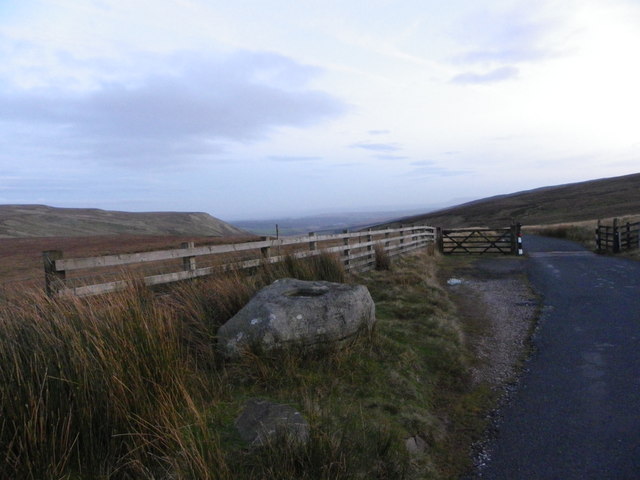 Bicycle ride Cross of Greet #79 Simon Warren 100 Greatest Cycling Climbs  - bike leaning against fence - distant view