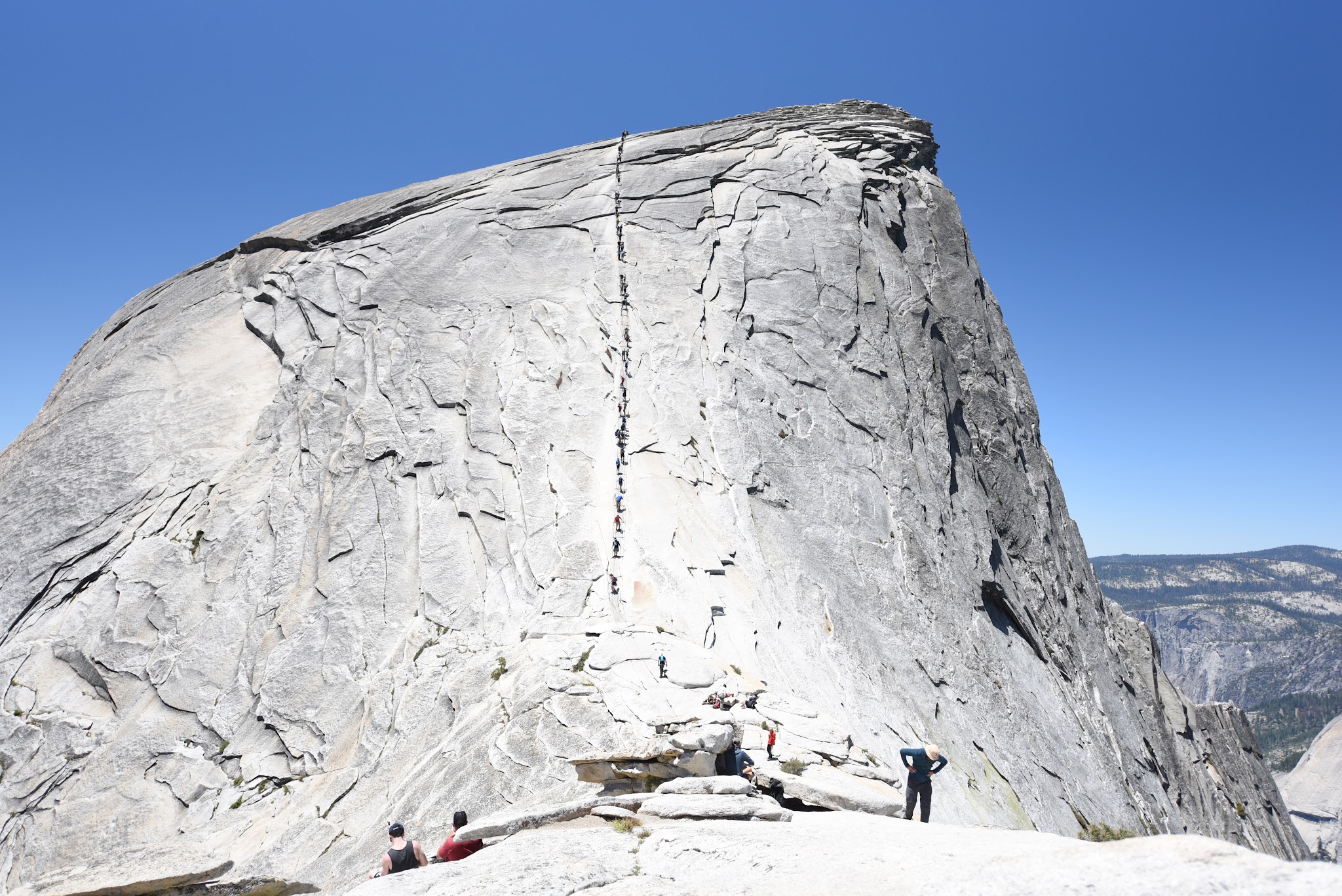 Bike - Hike Yosemite Valley to Glacier Point to Half Dome - hikers climbing Half Dome using cables