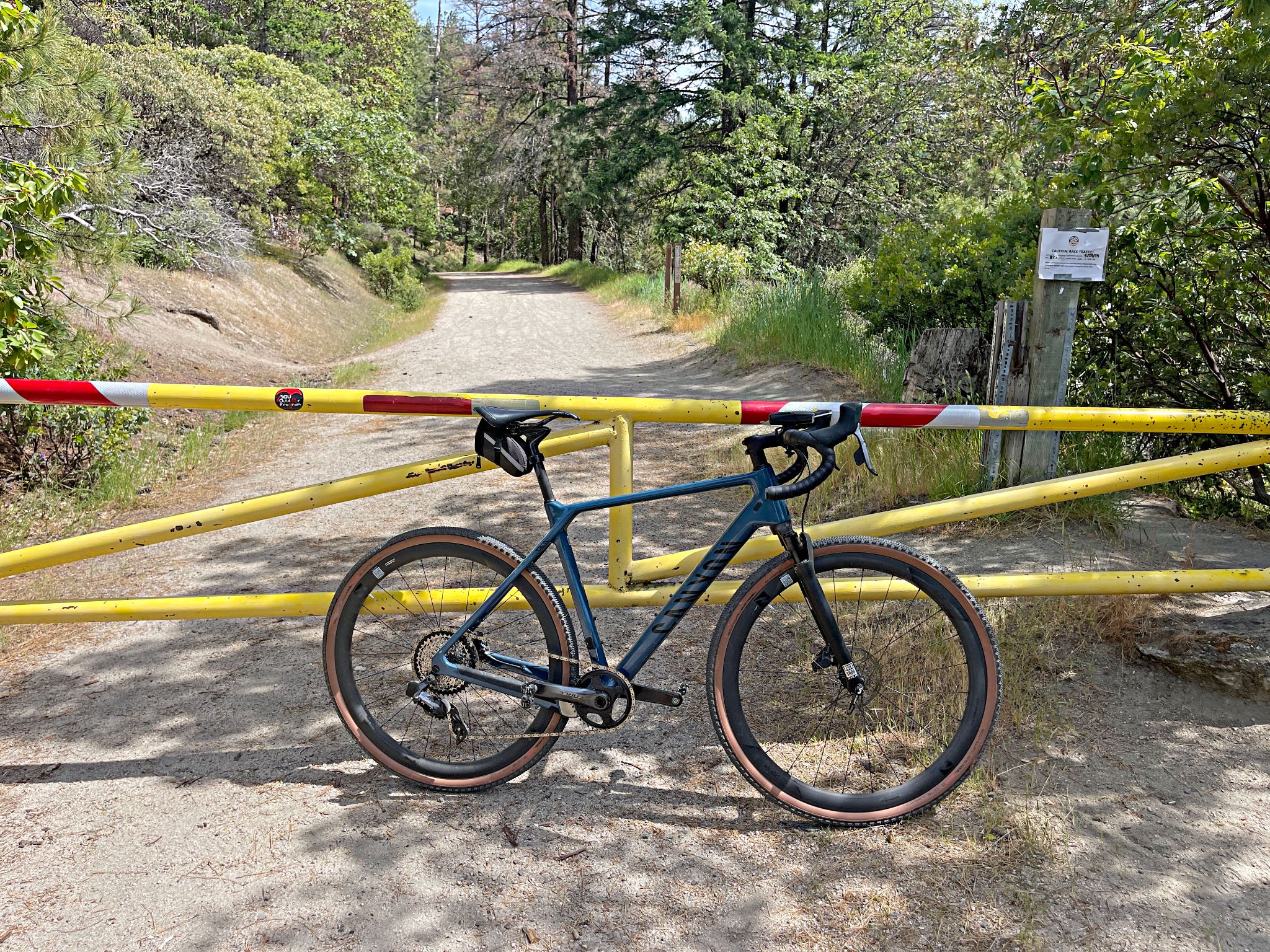 Cycling Mt. Ashland, Oregon via Loop Road: bike parked in front of yellow gate, blocking gravel roadway off to car traffic