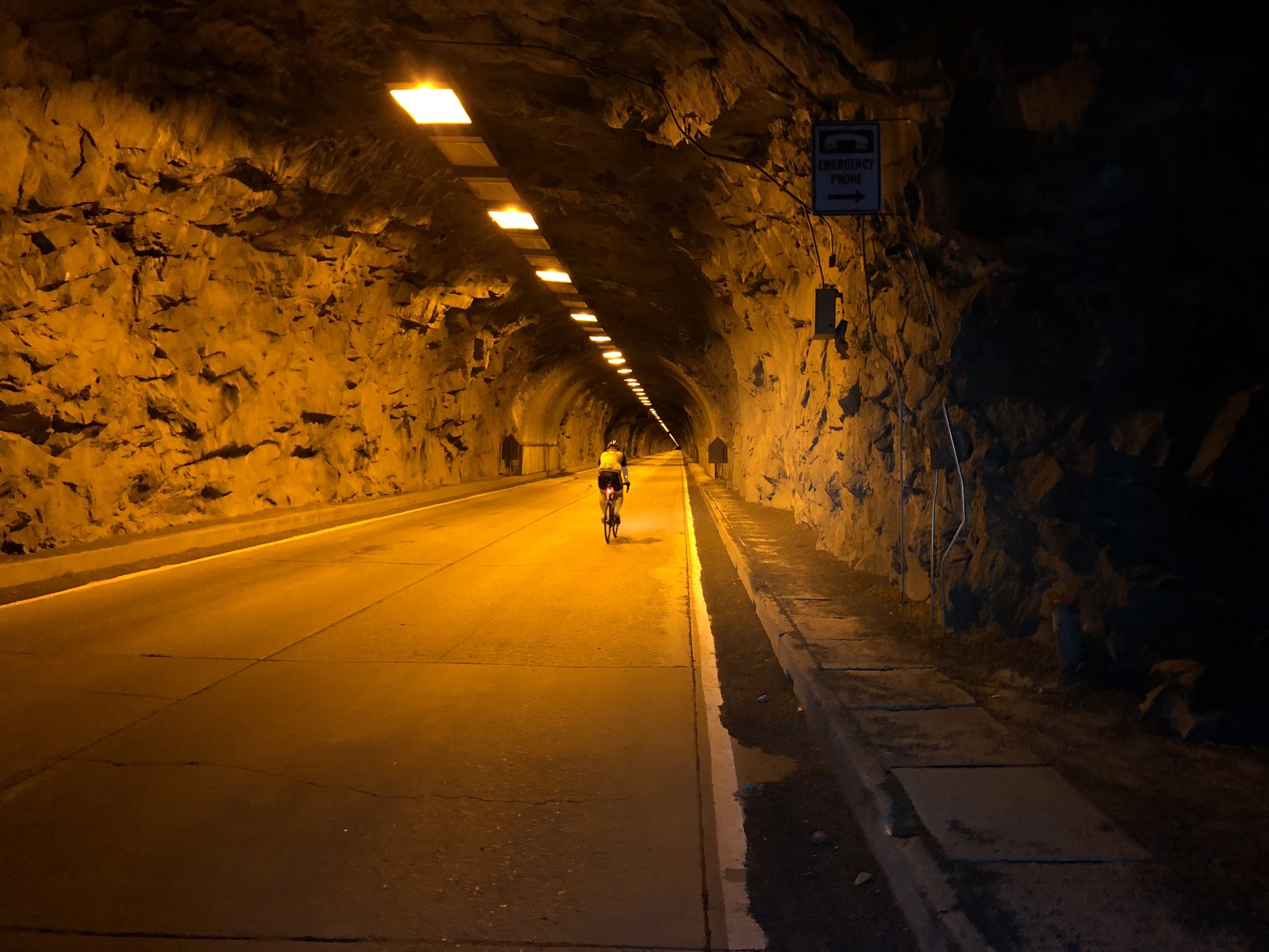 Cycling Glacier Point - cyclist riding bike in tunnel at Tunnel View Yosemite National Park