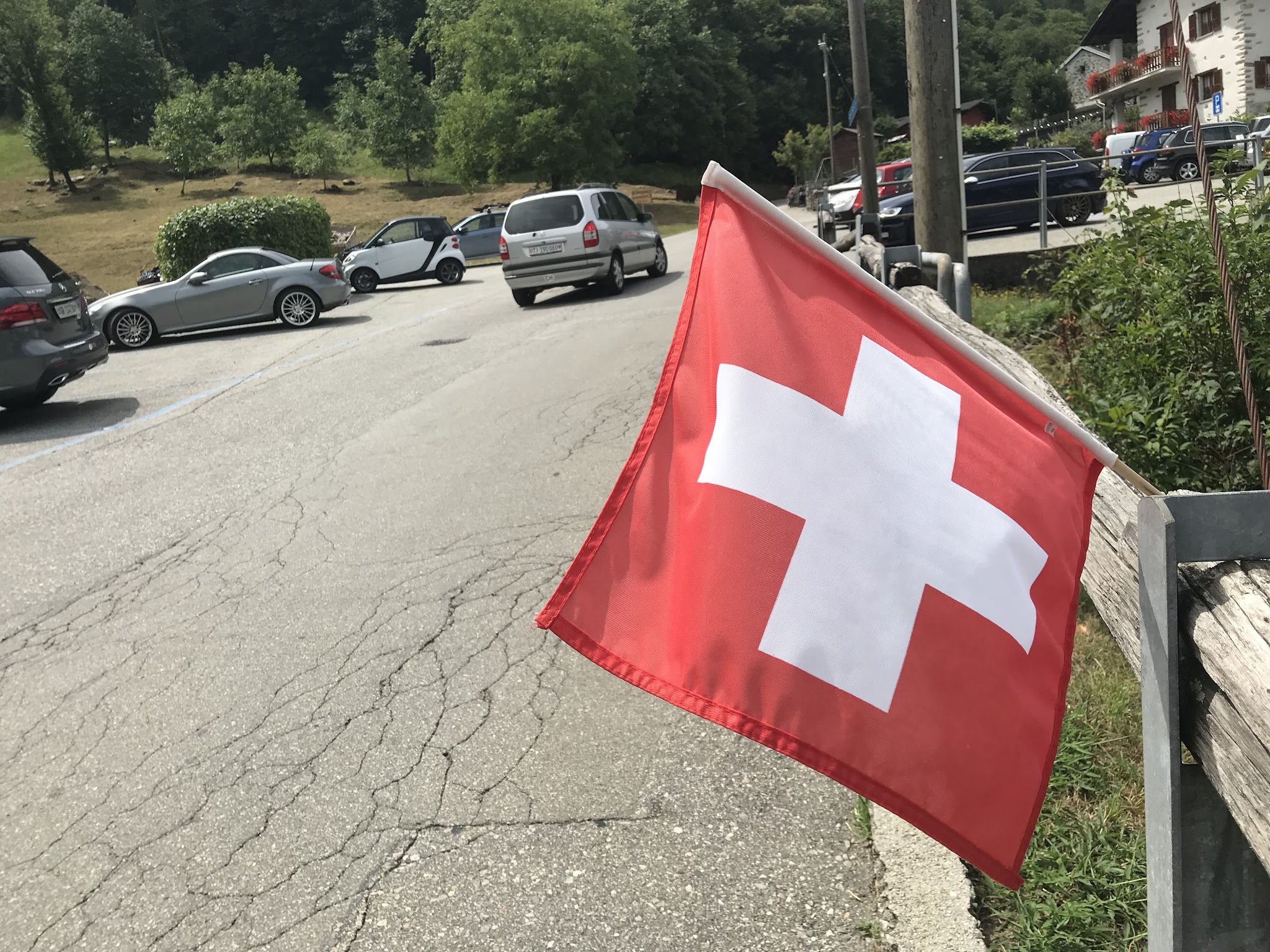 Bike climb Alpe di Cadinello  - swiss flag and road