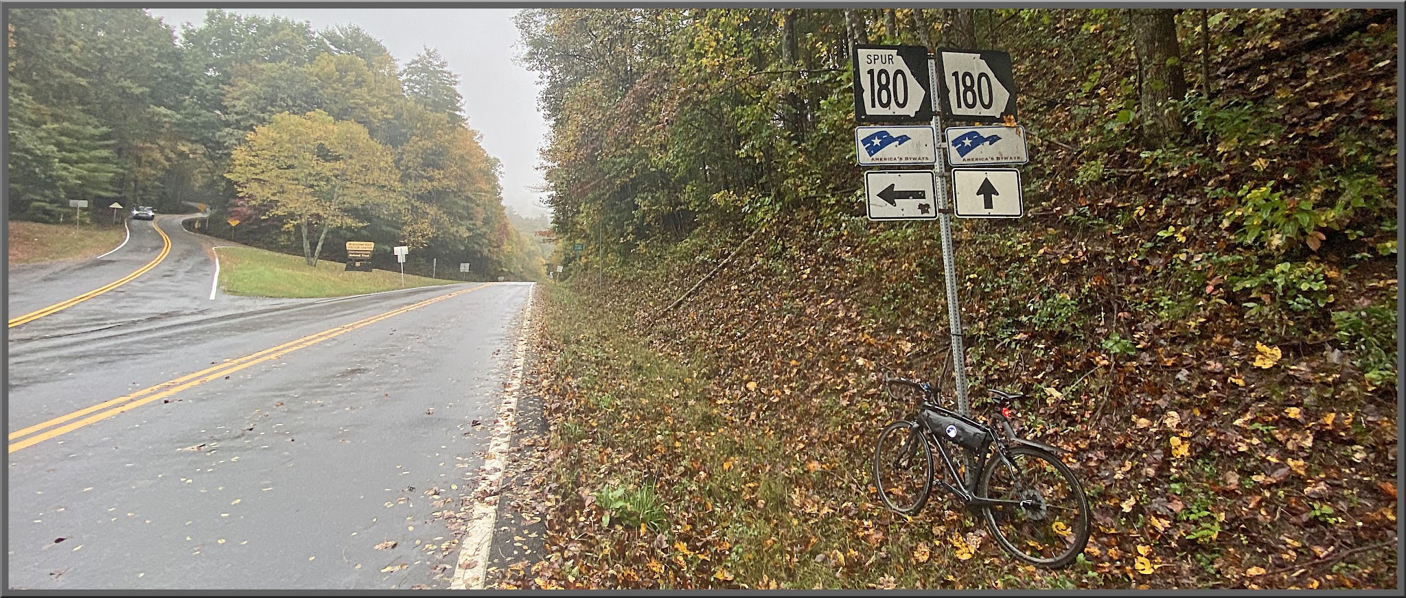 Cycling Jacks Gap South, Georgia - bike parked on roadside against signs for 180