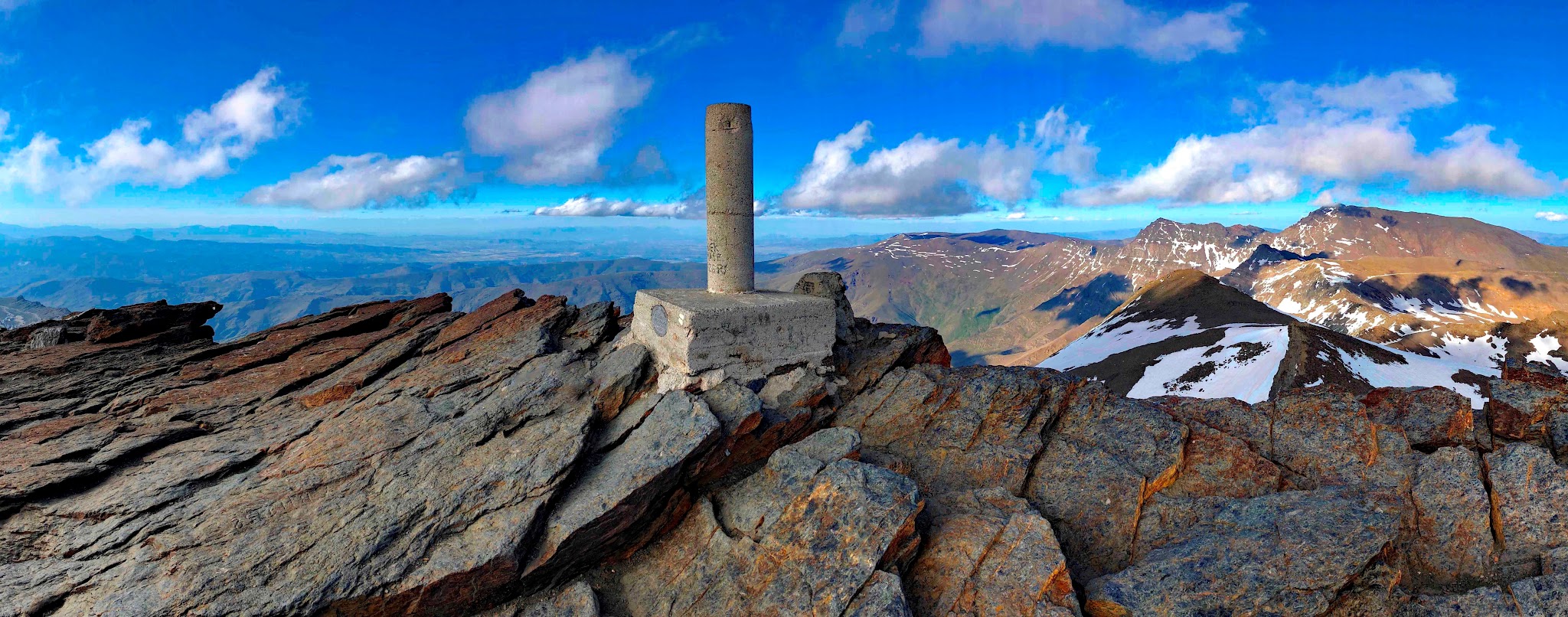 aerial view shows stone marker at the top of the climb
