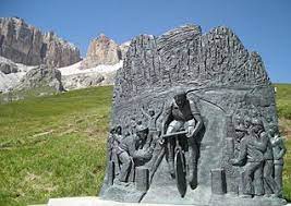 Cycling Passo Pordoi from Canazei - stone monument to Fausto Coppi