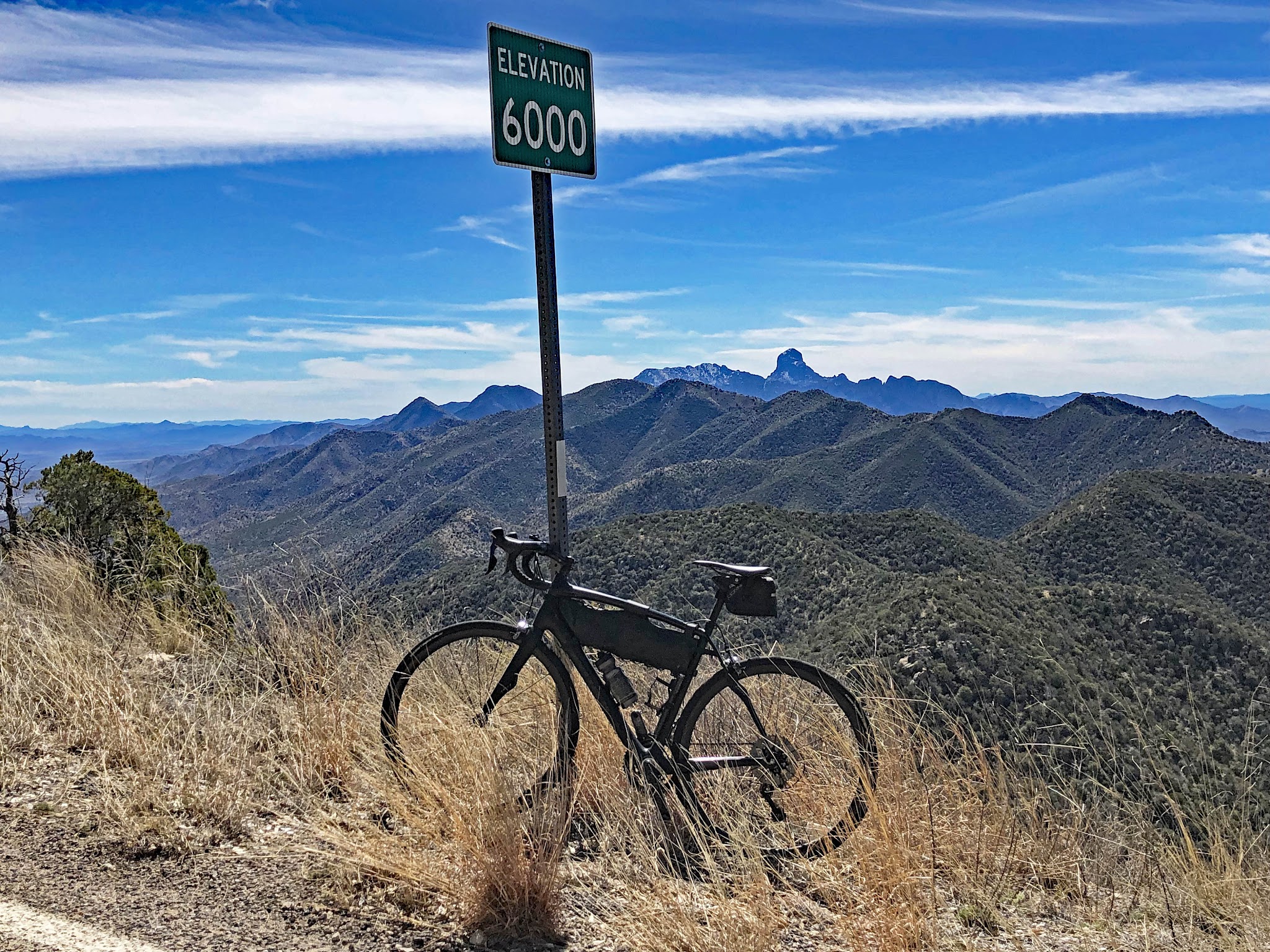 Climb by bike Kitt Peak - 5000' elevation sign with bike leaning against it