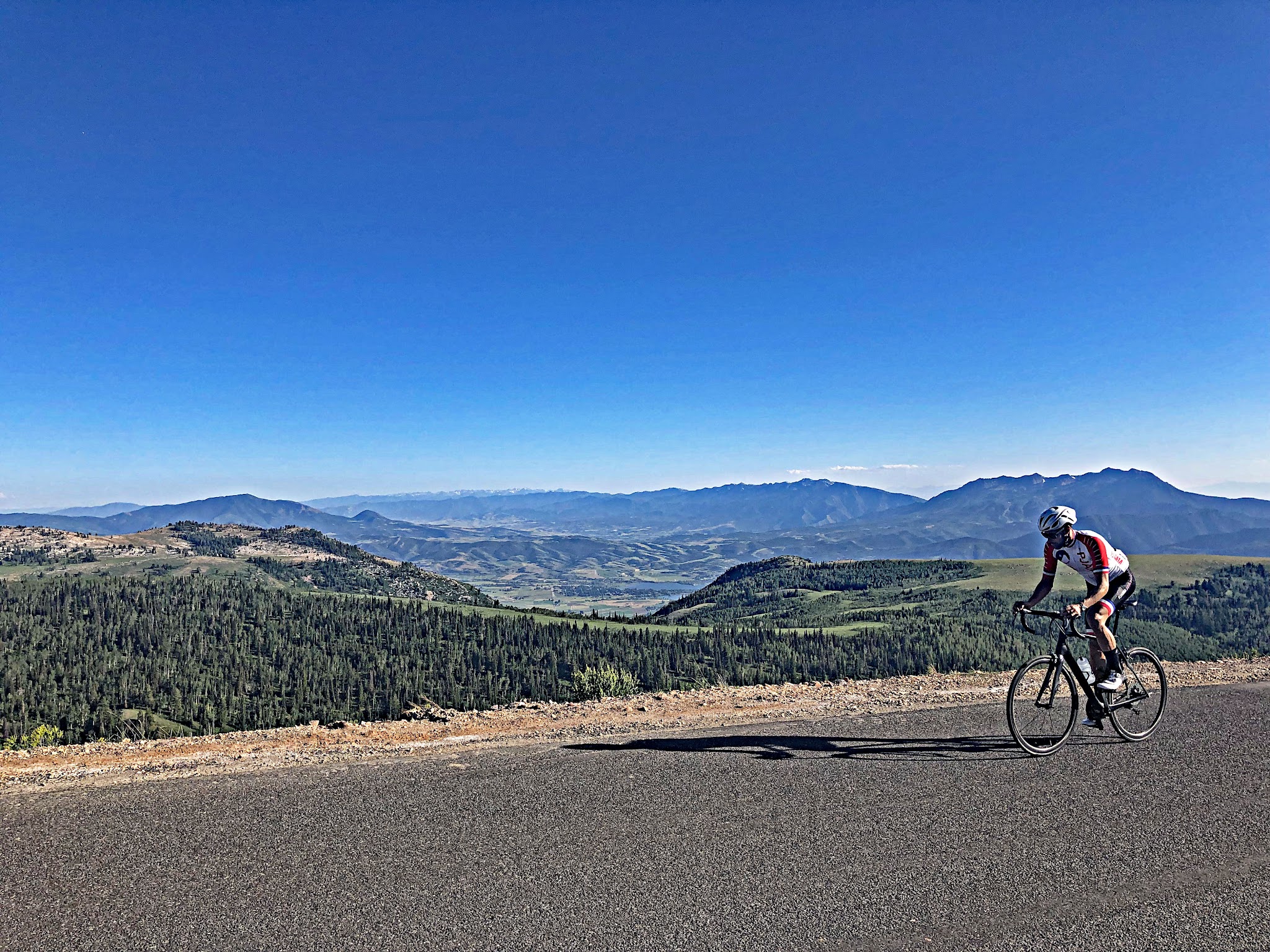 Summit Pass Road Sign with cyclist on Powder Mountain Utah bike climb.
