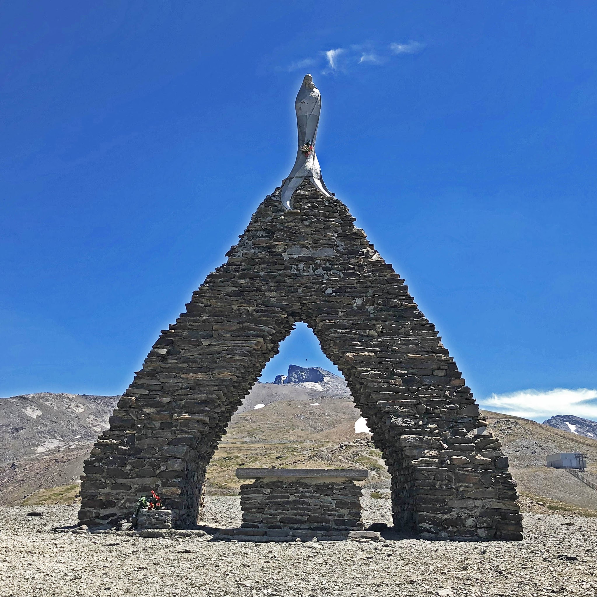 Bike climb of Pico de Veleta - statue of Virgen de Las Nieves, Pico Veleta seen through statue