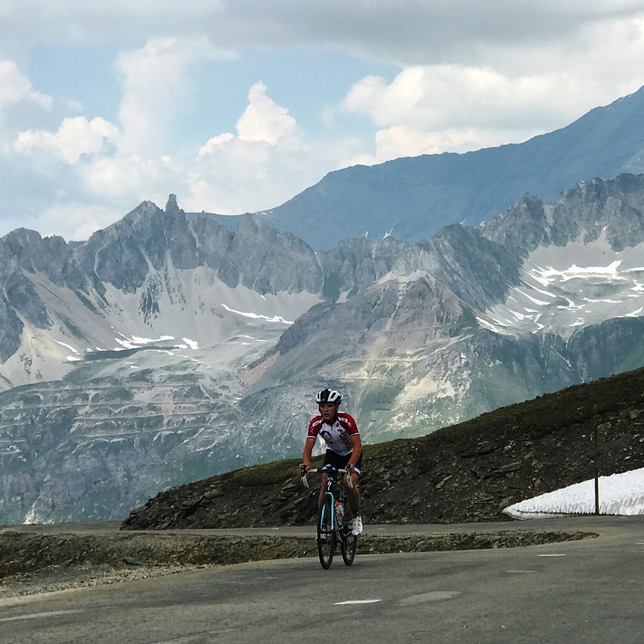 Cycling Col de l’Iseran - cyclist on bike, road, mountains, sky