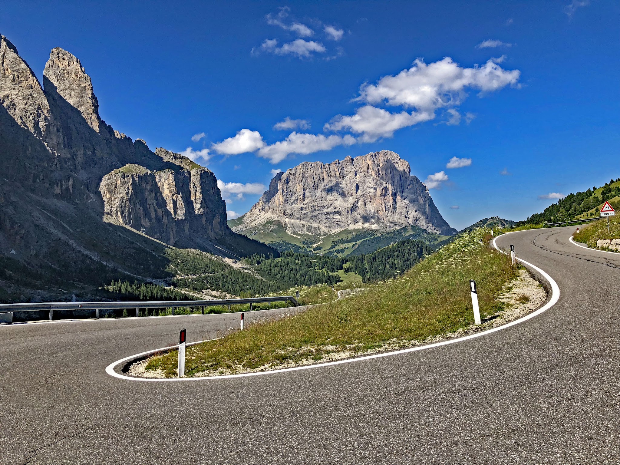 Bicycle climb The most gorgeous bike climbs in the world - Passo Gardena, Dolomites - tornante with rock formations in background