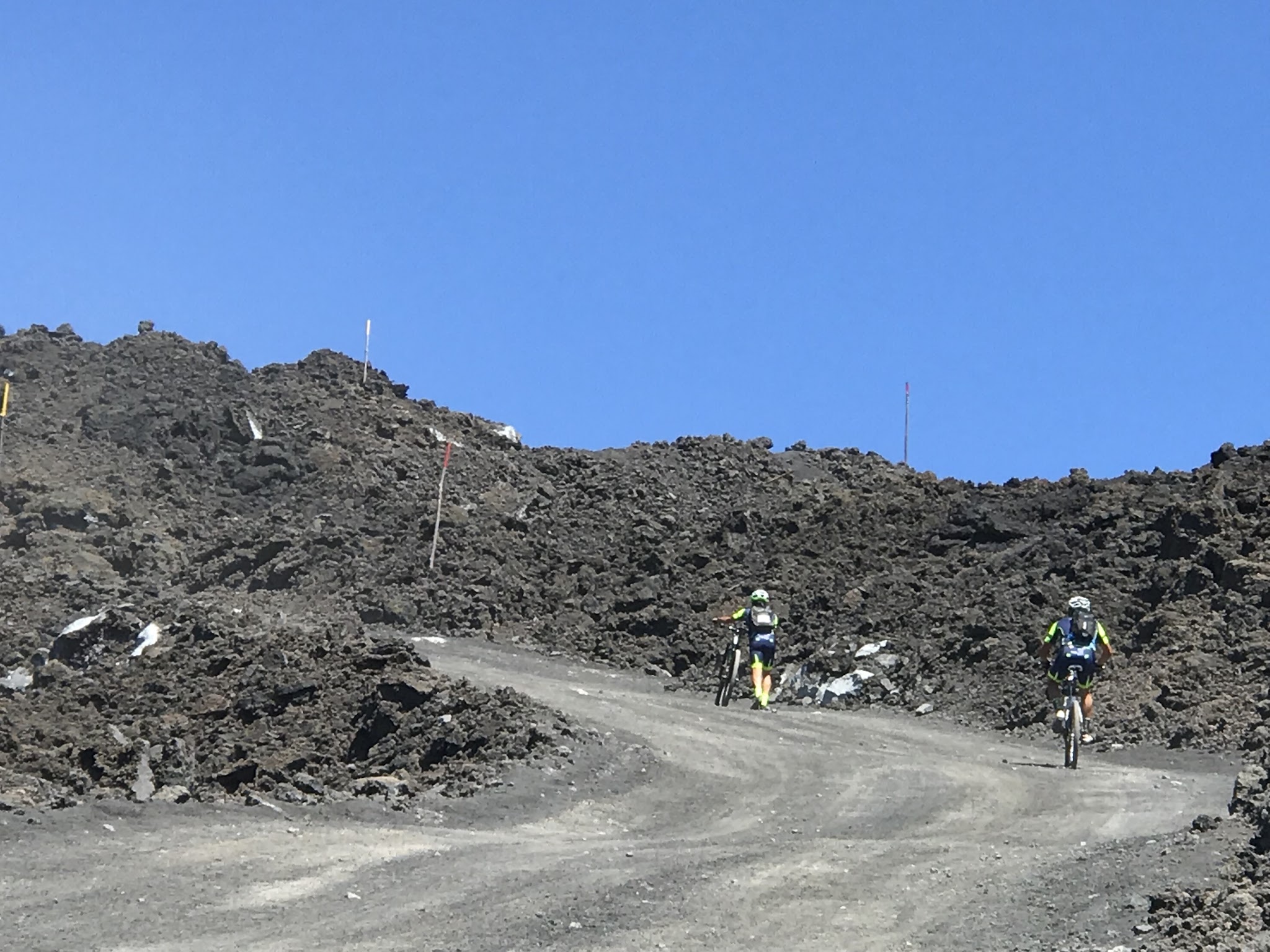 2 mountain bikers on gravel and dirt road to Mount Etna