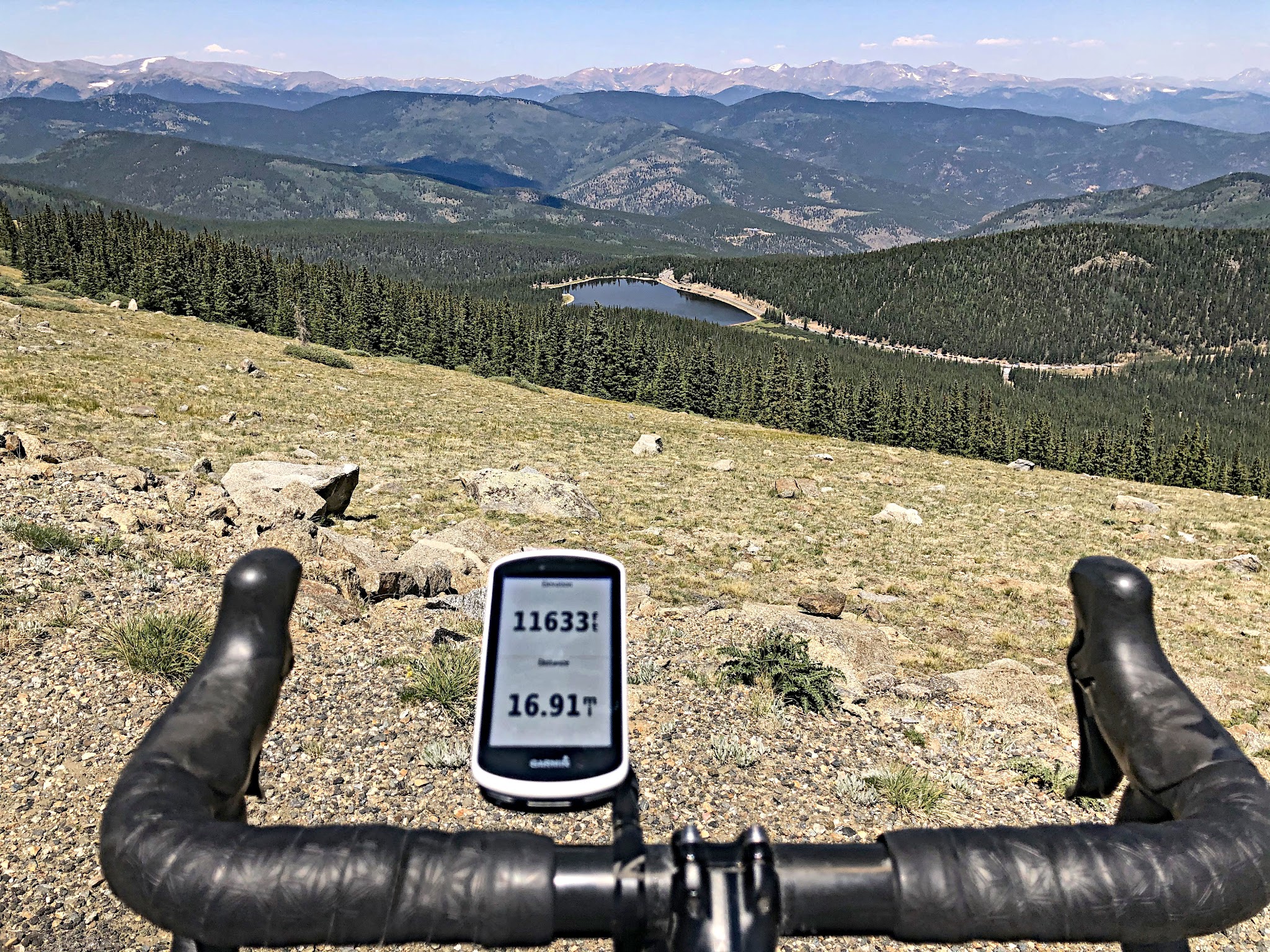 Cycling Mt. Evans, Colorado Cycling Mt. Evans, Colorado - bike handlebars and Garmin looking over hillside, above treeline, Garmin reads 11633 feet elevation
