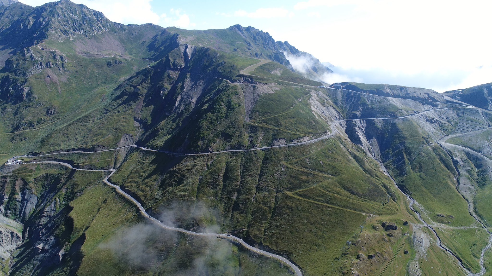 Cycling The French Pyrenees - Col du Tourmalet - aerial drone photo of mountain, hairpins and summit