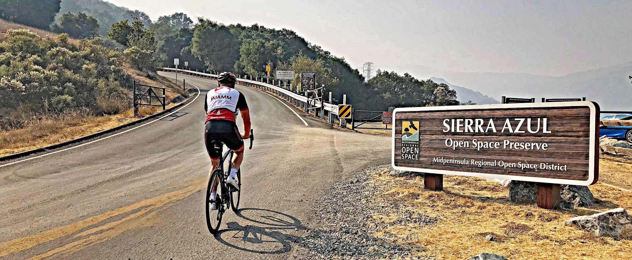 Cycling Mt. Umunhum - PJAMM cyclist on bike entering Sierra Azul Open Space Preserve on Mt. Umunhum Road