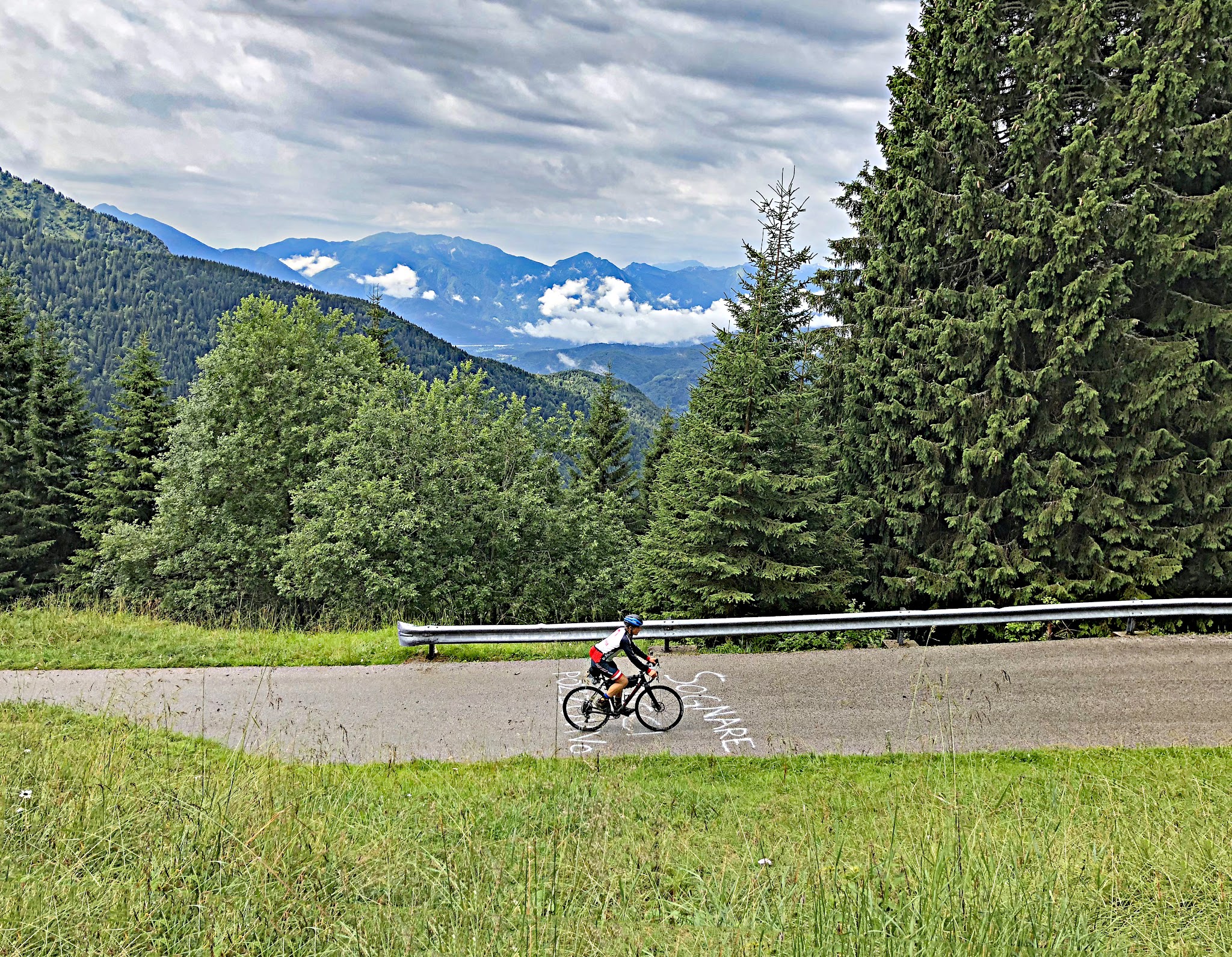 Cycling Monte Zoncolan from Ovaro - cyclist below riding on road over giro d'italia paint