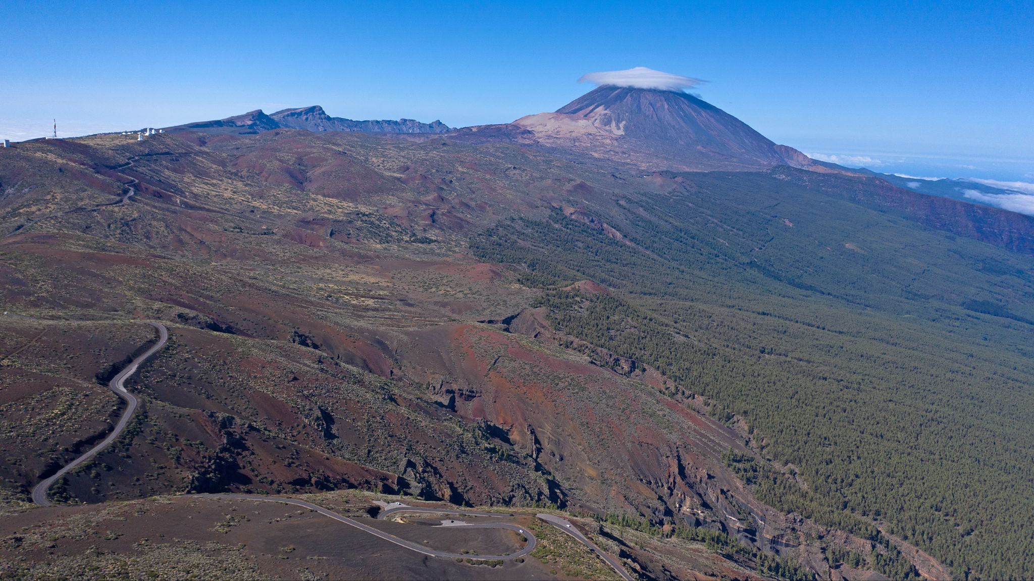 view looking back over the roadway with cloud topped Mt. Teide in distance.