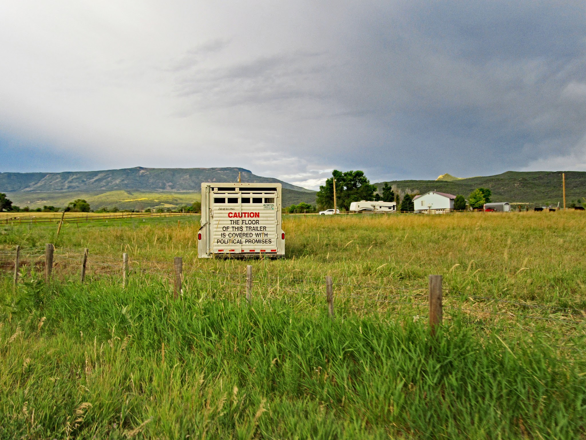 Bike climb of Grand Mesa North - horse trailer in field with sign