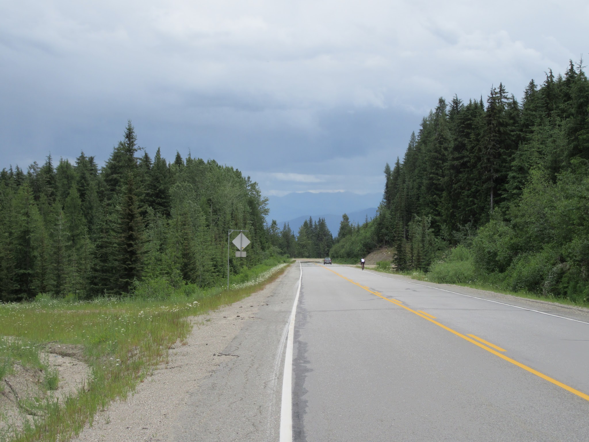 Cycling Strawberry Pass, BC, CAN - cyclists descending roadway