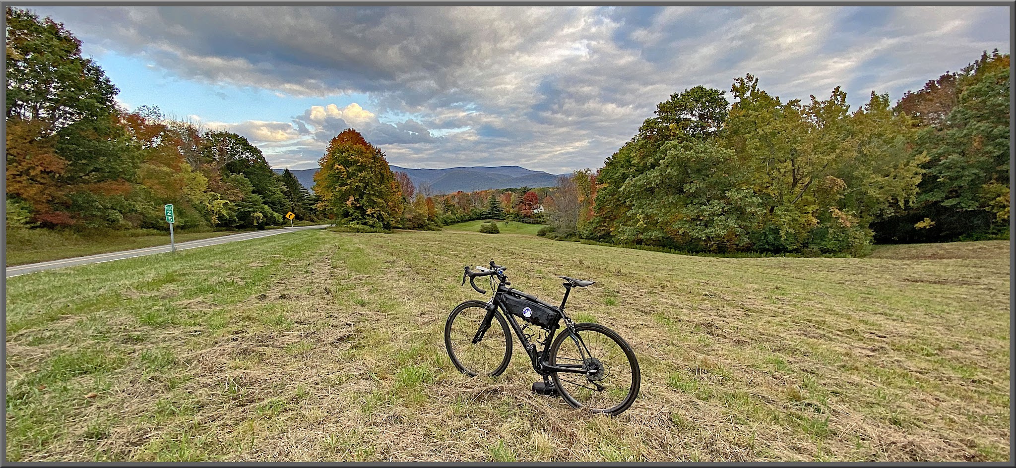 Cycling Petersburg Pass, Massachusetts - bike parked in green field on side of road, fall foliage