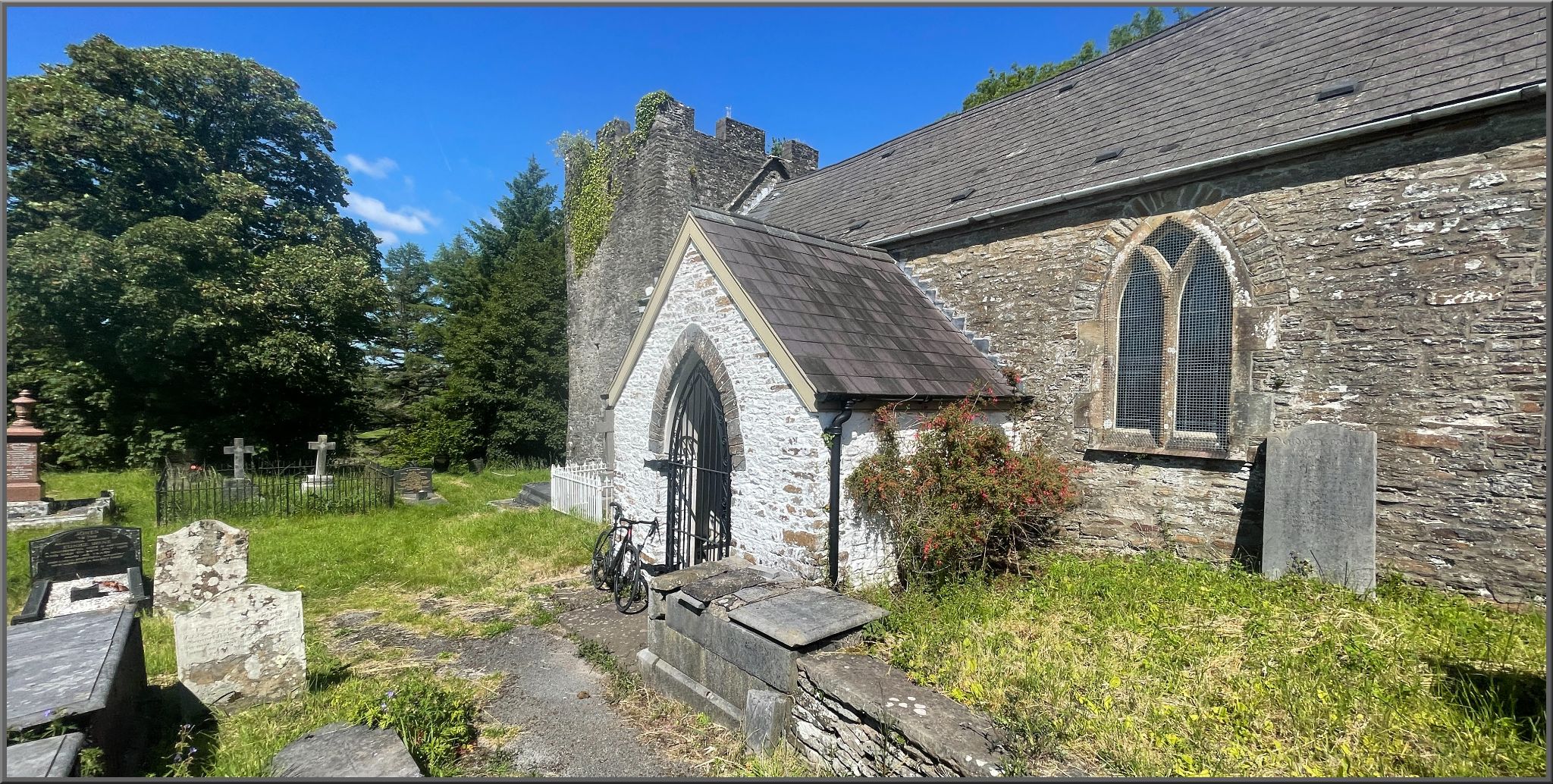 Cycling Llanguicke Road, Wales Historic Llangiwg Church at climb's finish, old stone church