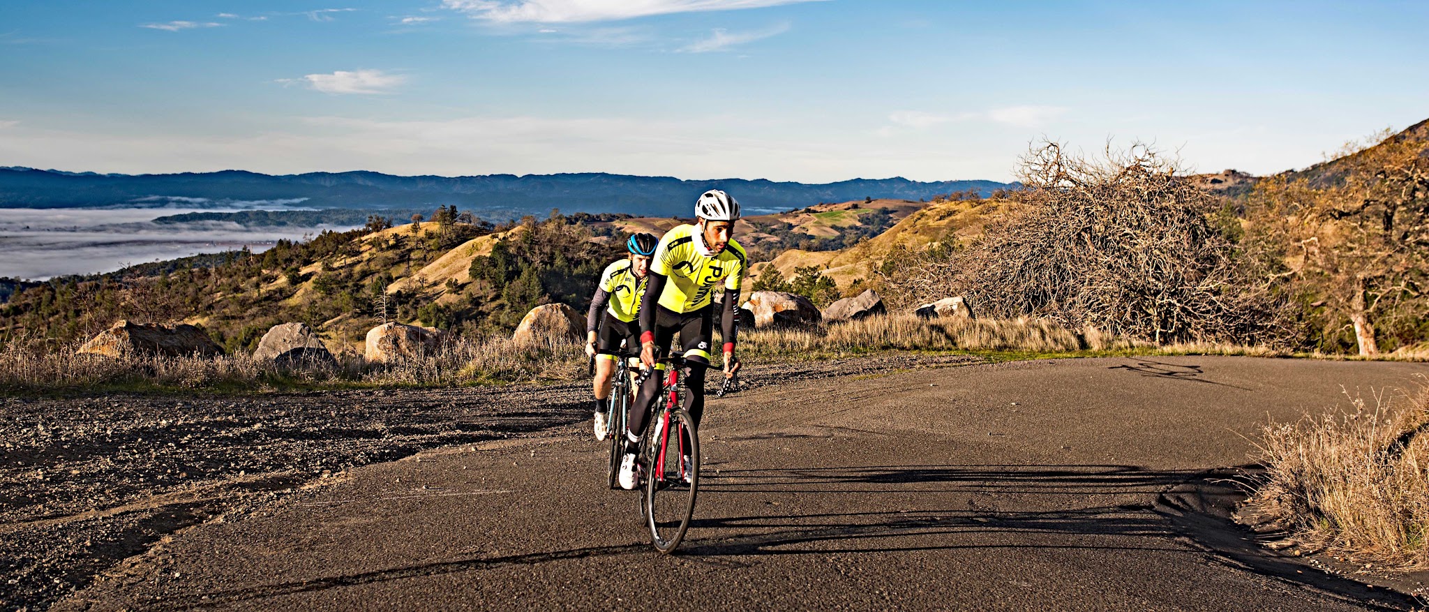 Climbing Pine Flat Road by bike - aerial drone photo of roadway, hillside, mountains and vineyards.