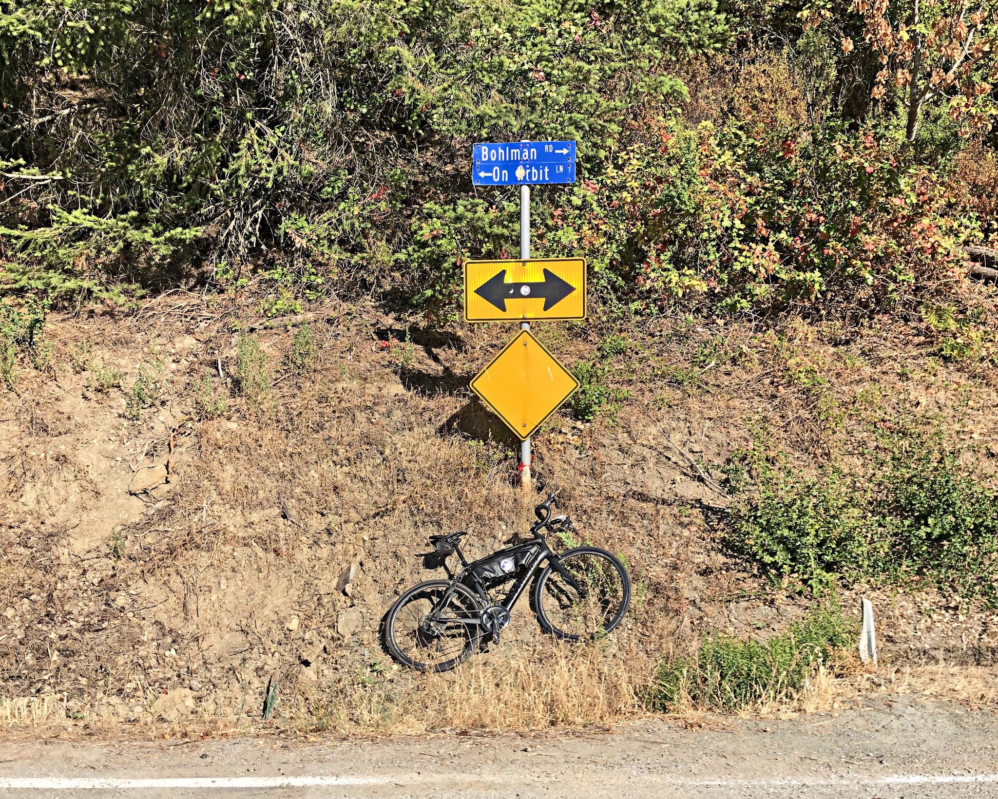 Cycling Bohlman On Orbit - bike parked against road sign for Bohlman and On Orbit roads