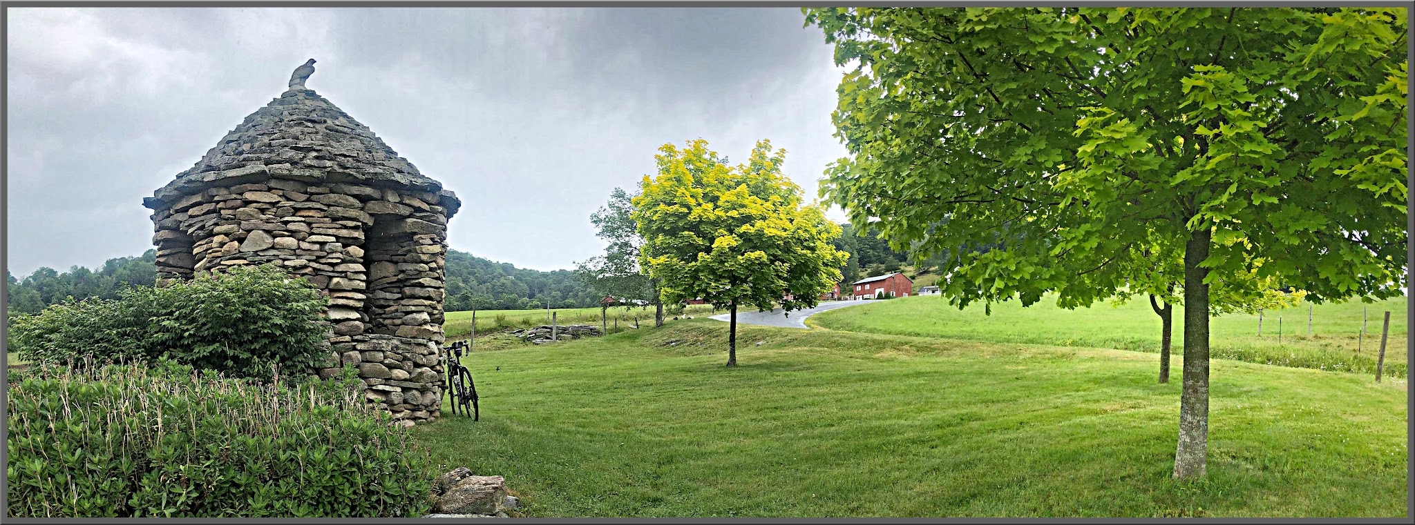 Cycling New York State - Glade Hill, bike parked against Stone Gazebo in green field 
