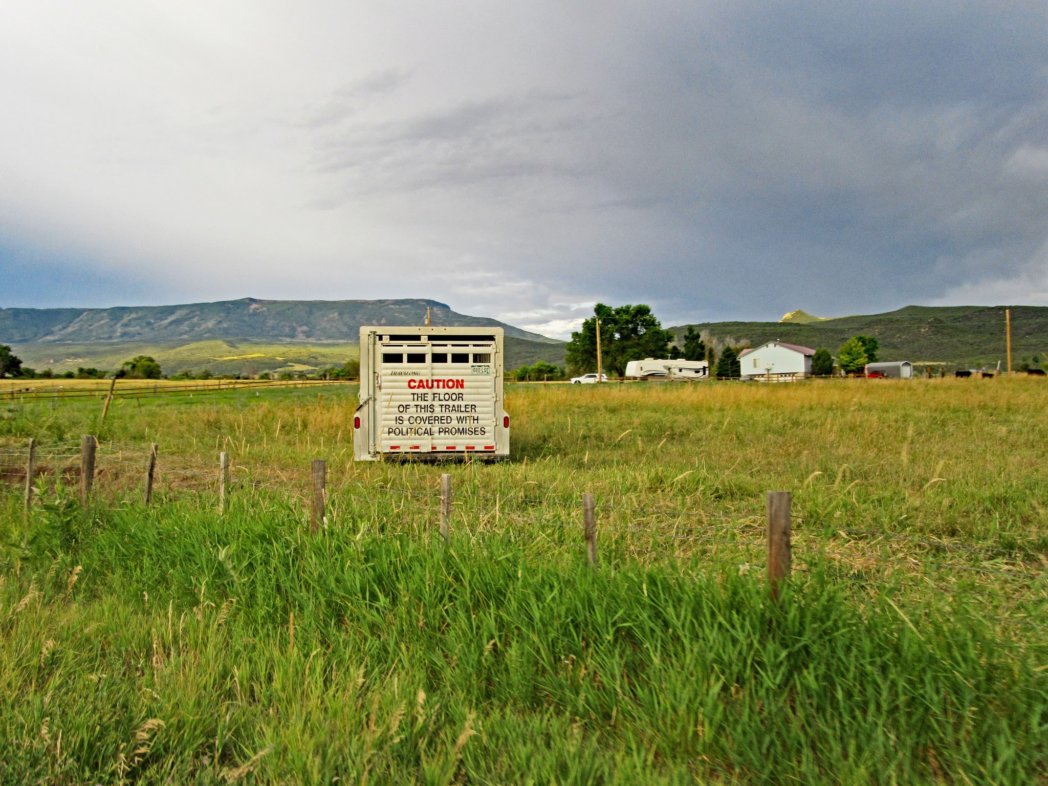 Bike climb of Grand Mesa North - horse trailer in field with sign
