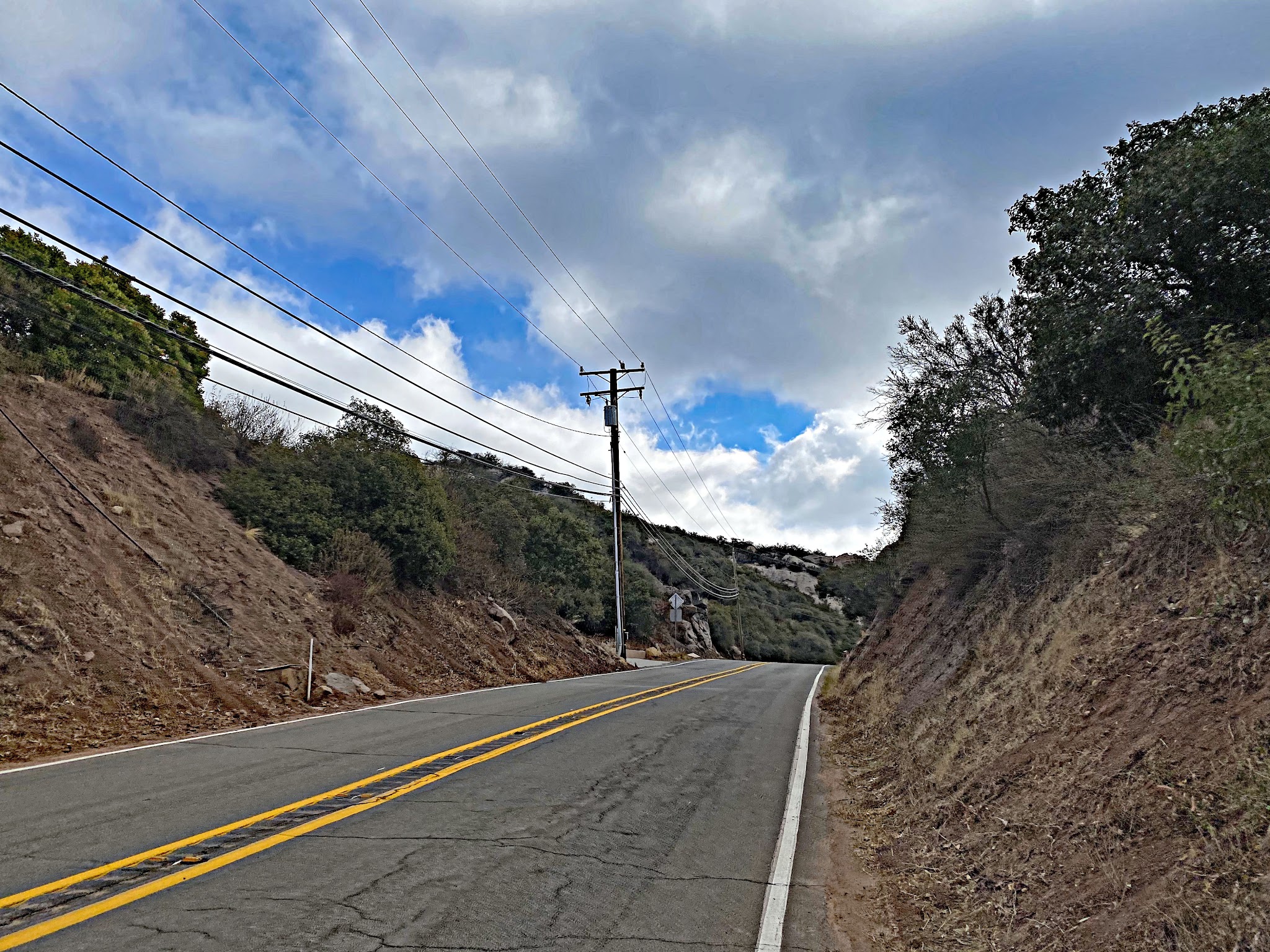 Cycling Malibu Canyon Road to the top of Piuma Road - climb finish, two lane roadway, W. Saddle Peak Road on the left