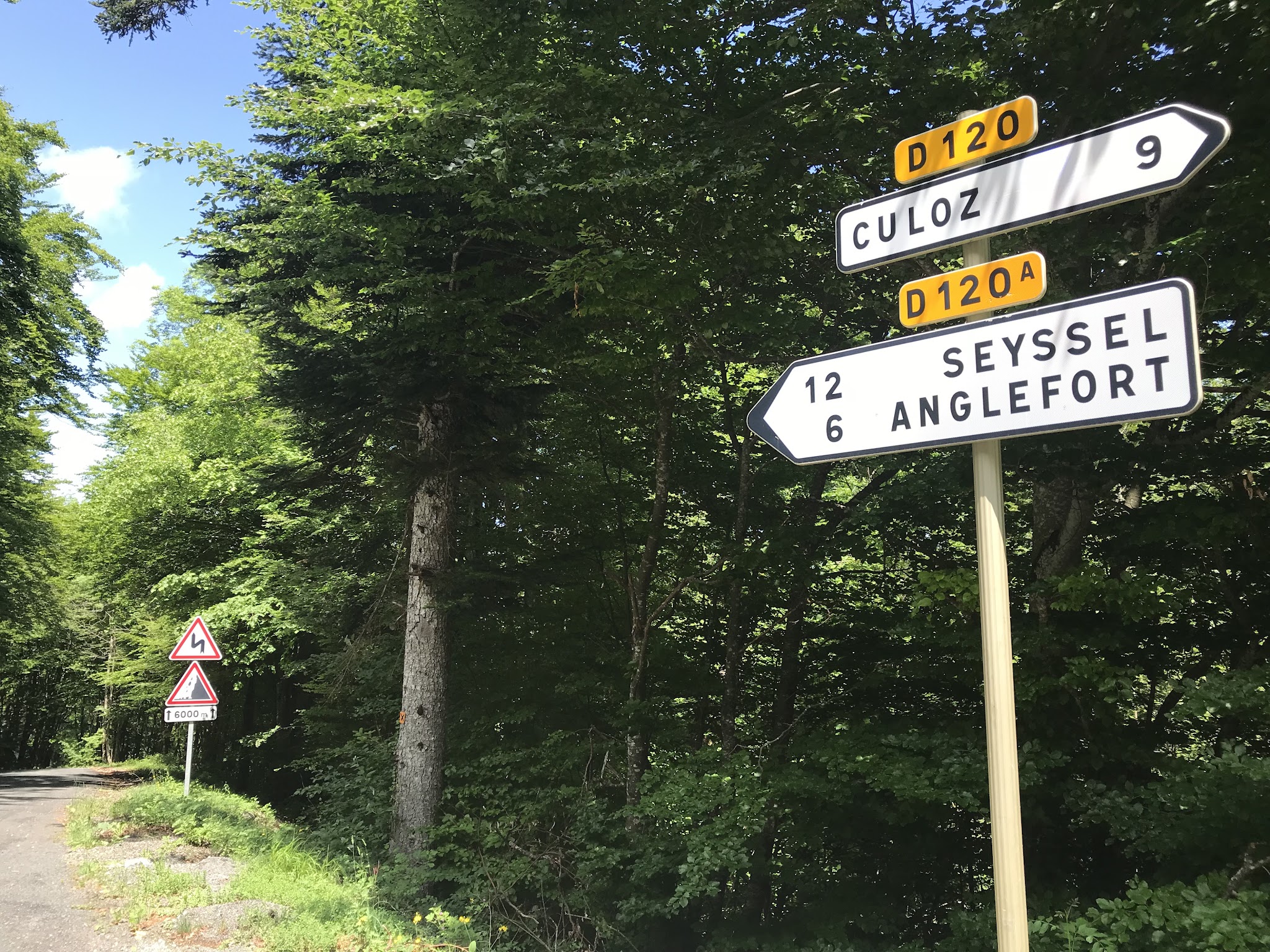 road signs at the intersection of the Anglefort and Coloz routes up Col du Grand Colombier