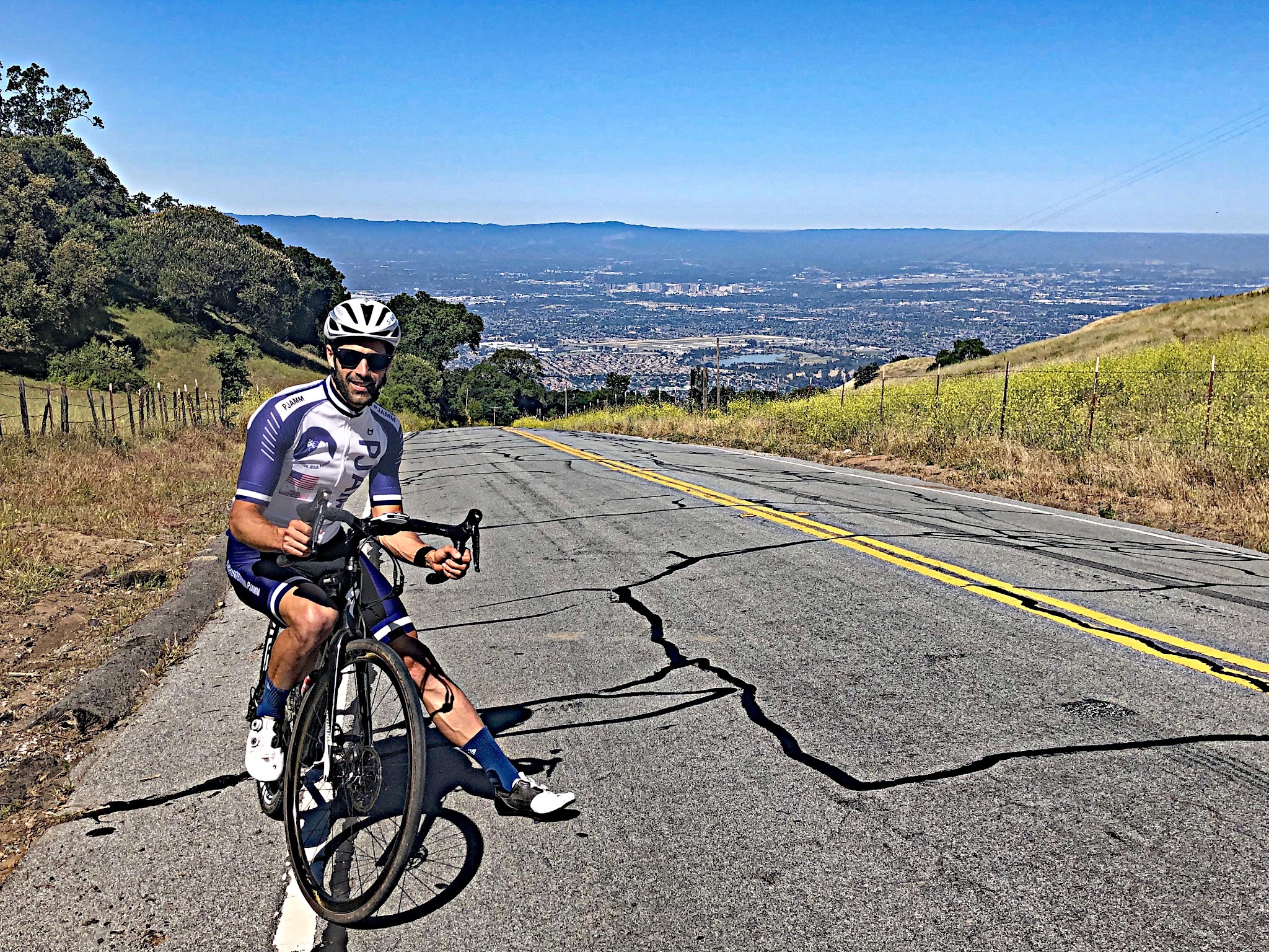 Cycling  Quimby Road - PJAMM Tayler Hockett on bike with San Jose in background