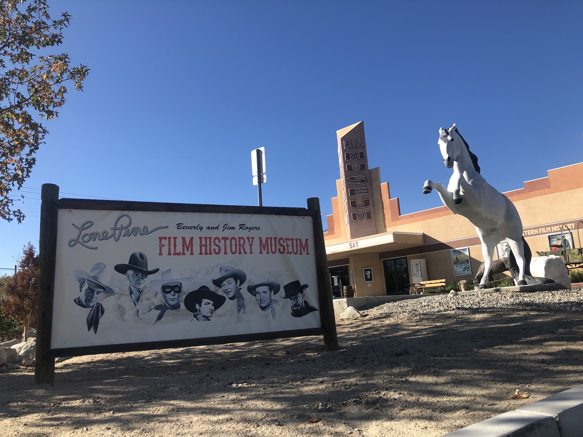 Film History Museum, Lone Pine, California sign in front of Lone Pine's Film History Museum, large horse statue behind sign