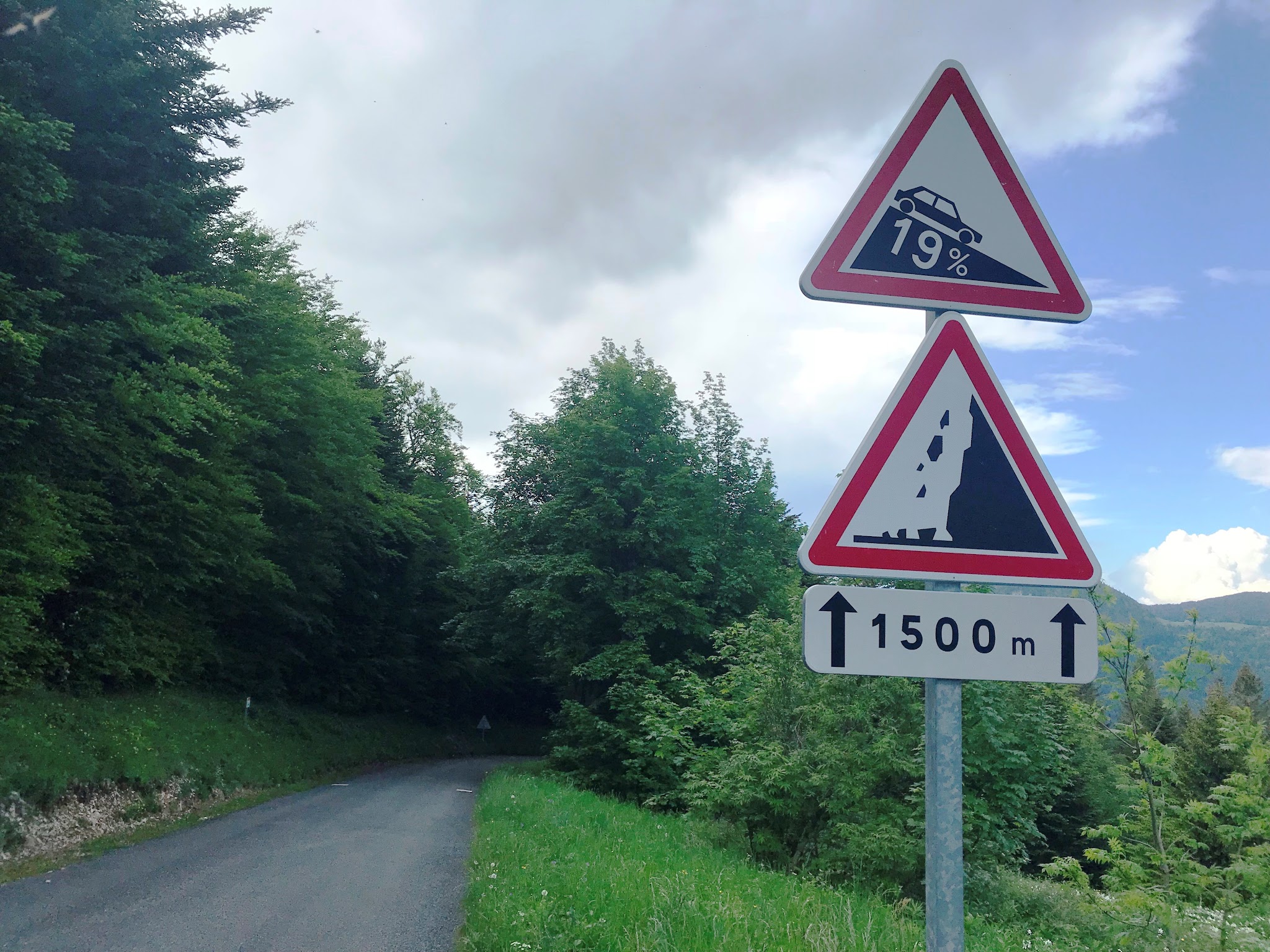 road signs warn of 19% grade and falling rock