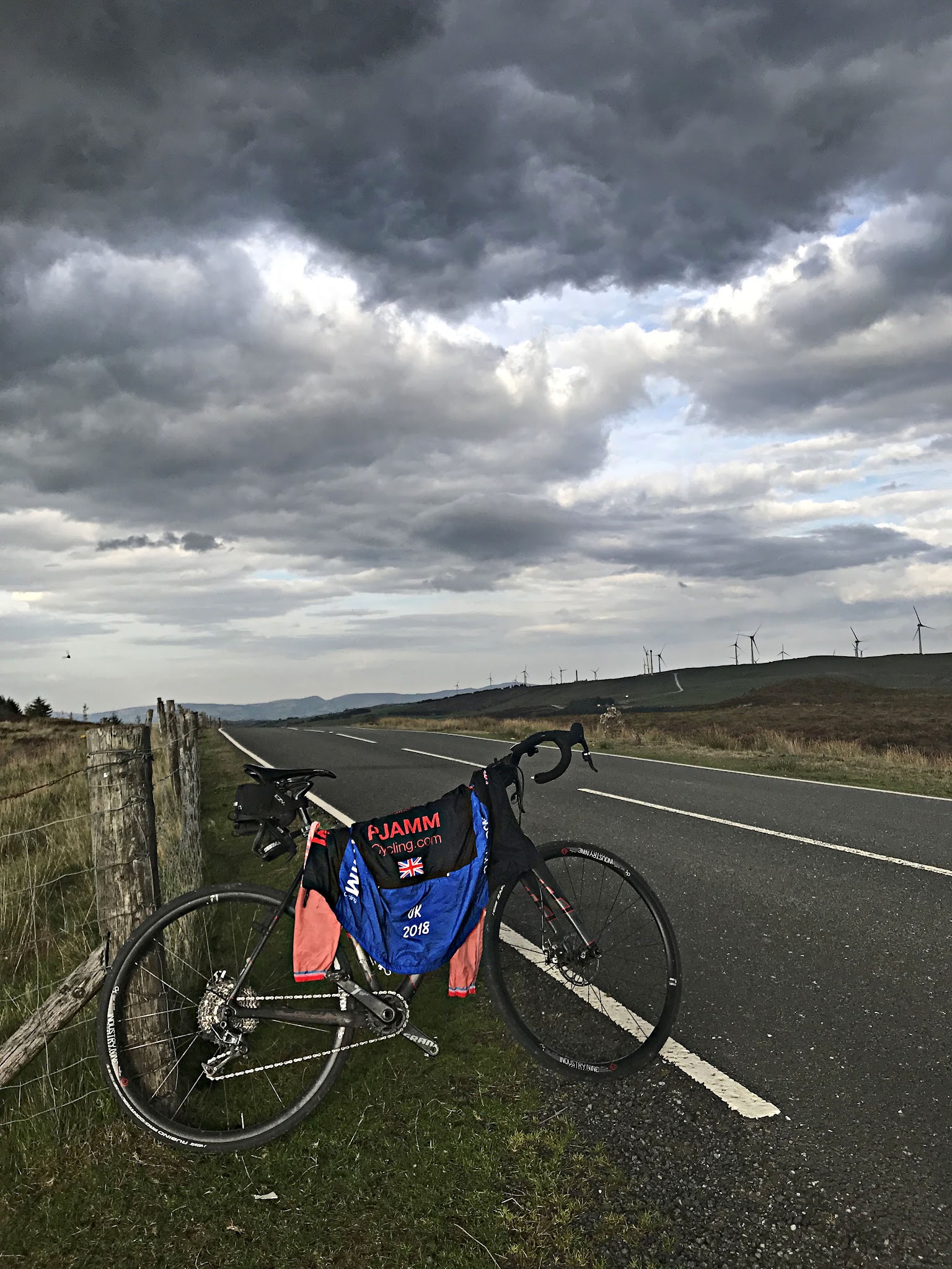 Cycling The Road to Hell, Wales - PJAMM Cycling jersey draped across bike parked along section of two-lane roadway