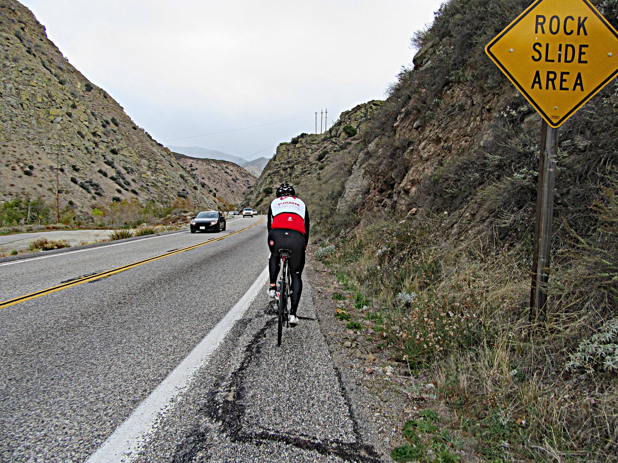 Riding bike through canyon at start of Onyx Summit bicycle climb.