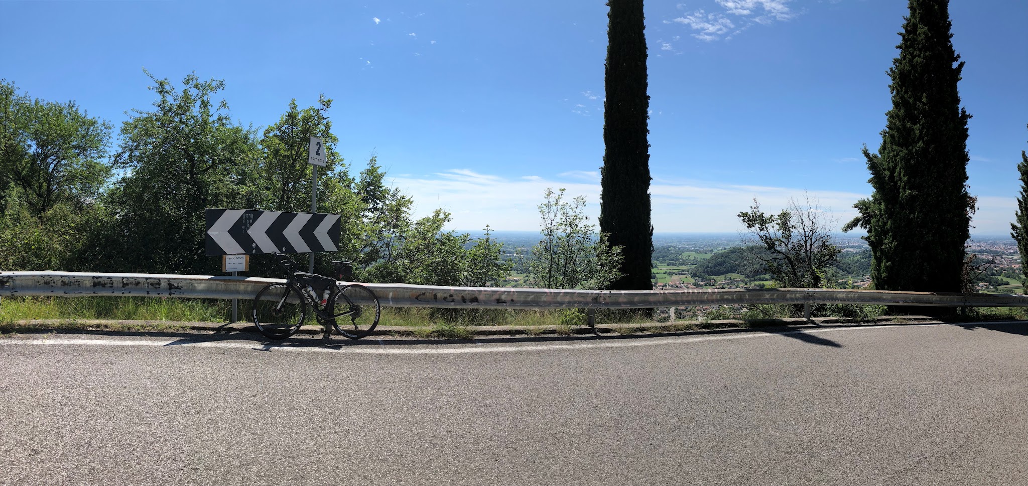 Climbing Monte Grappa from Possagno  by bike - bike leaning against tornante (hairpin) 2