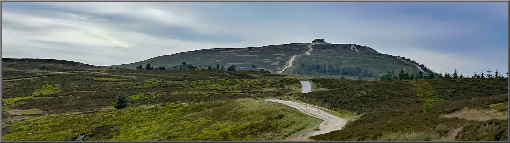narrow country roadway stretches up green hillsides to Jubilee Tower