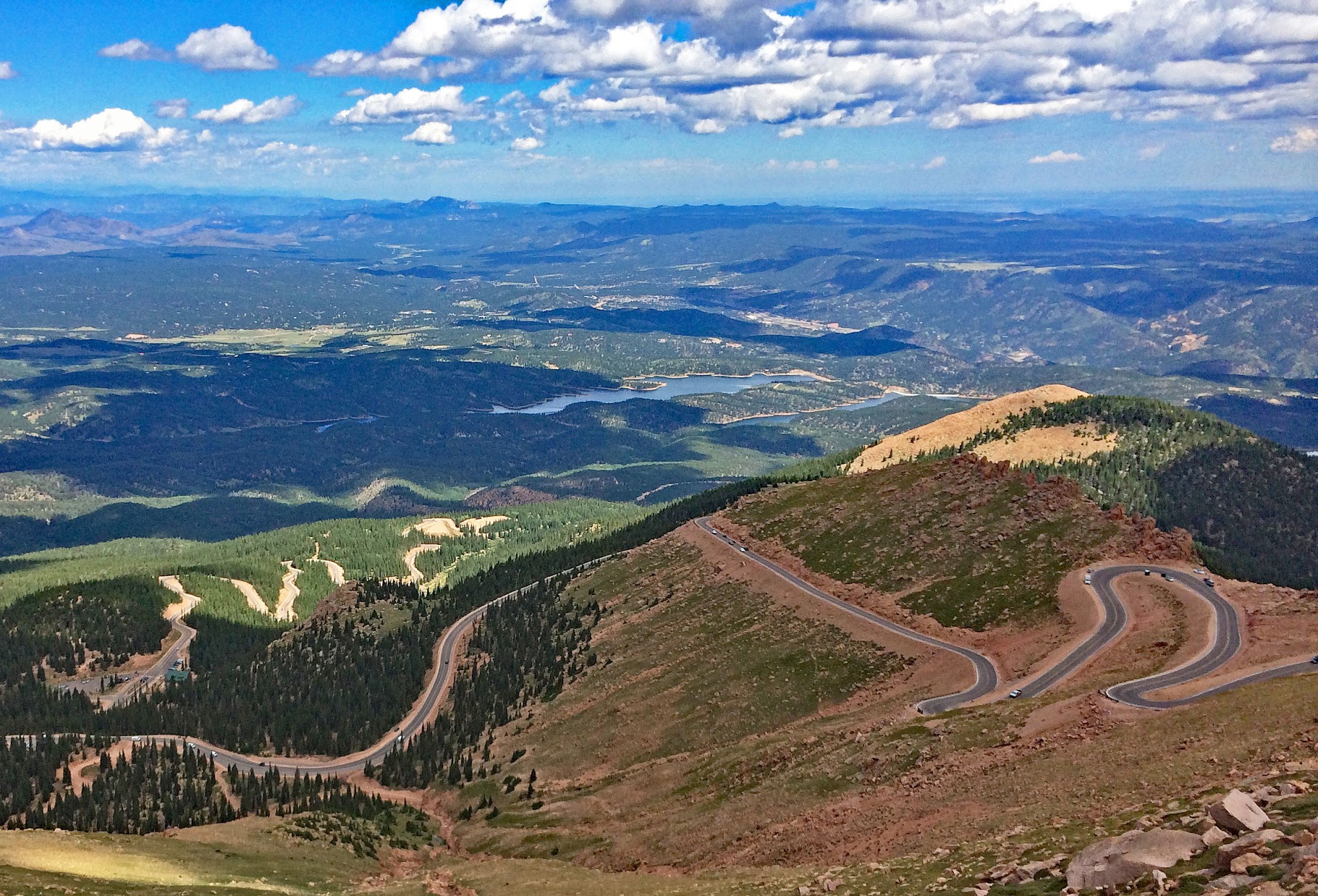 Hairpins on Pikes Peak - cyclists riding by bike up climb