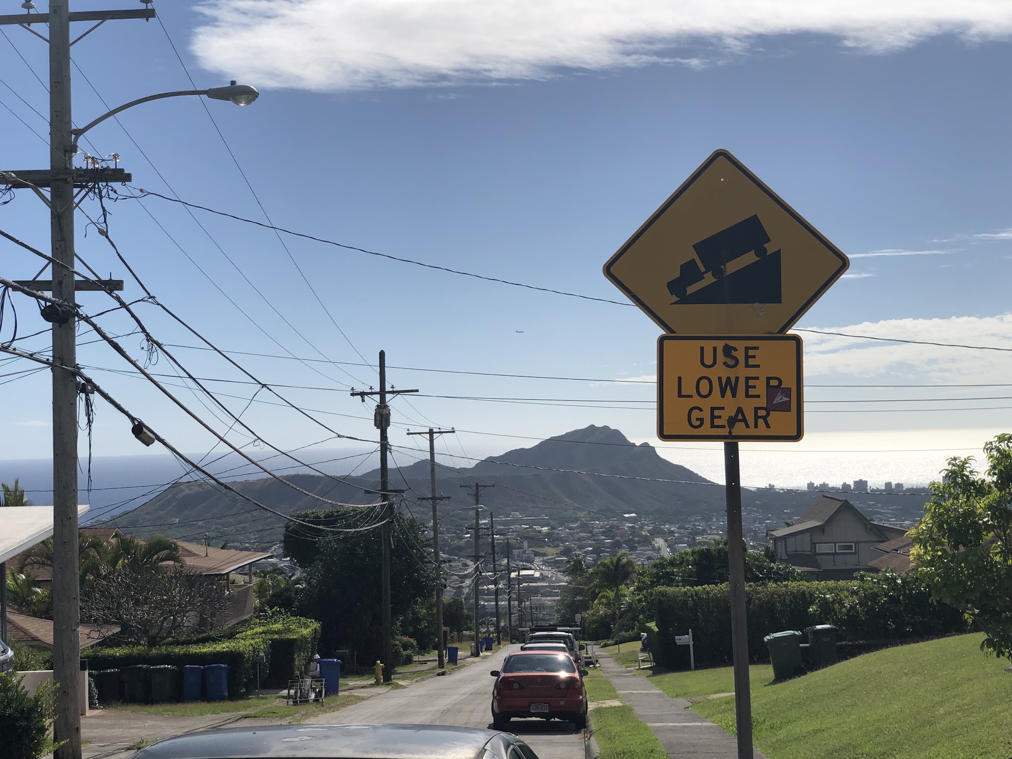 Bicycle climb up Wilhelmina Rise - steep grade sign, steep street and Diamond Head