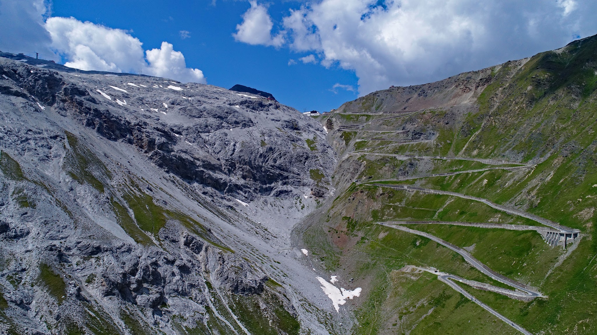 Climbing Stelvio by bike from Prato alla Stelvio - aerial drone photo of tornanti (hairpins) leading to the pass, top of stelvio