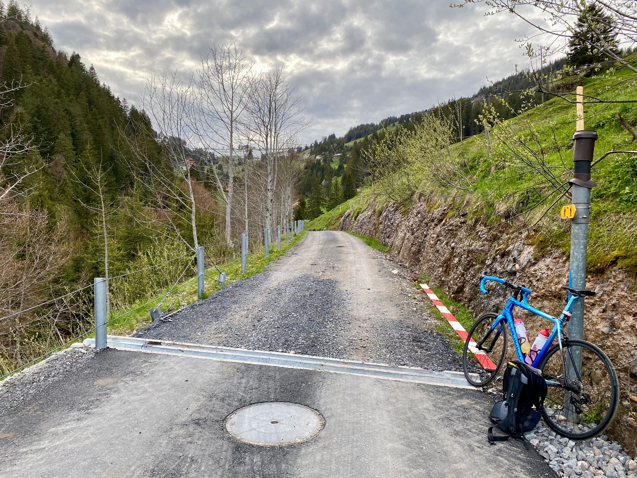 Cycling Mount Rigi, Switzerland - bike stopped along roadside, narrow, one-lane, gravel roadway 