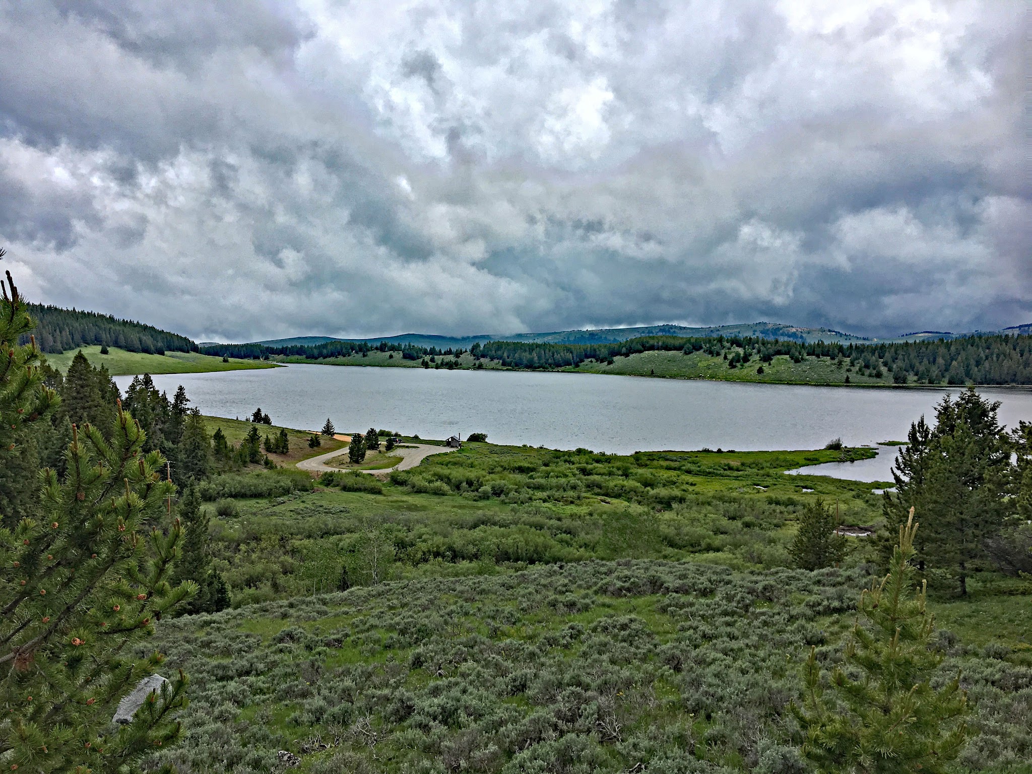 Cycling Powder River, Wyoming - Meadowlark Lake, small lake surrounded by greenery and evergreen trees