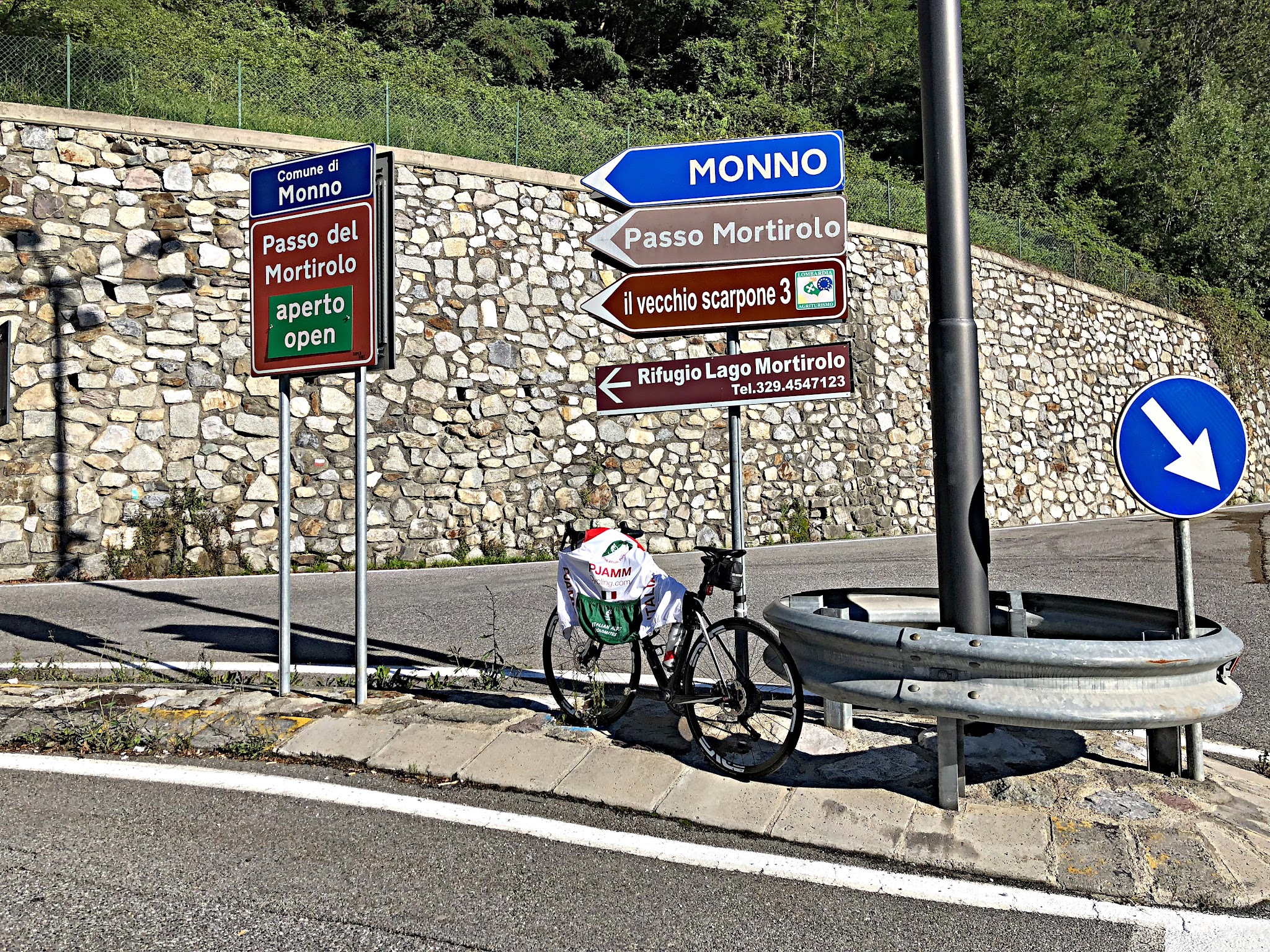 Passo del Mortirolo from Edolo Climbing Passo del Mortirolo from Edolo - roadway sign with bike leaning against it.