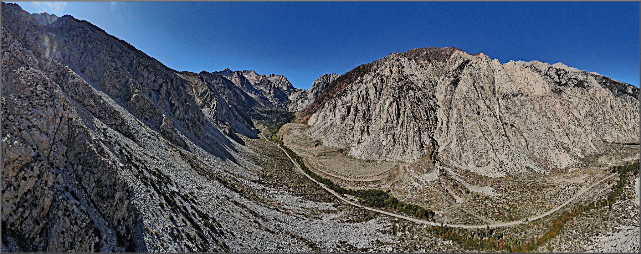 Cycling Pine Creek Road, California - aerial drone view of roadway surrounded by high rock walls
