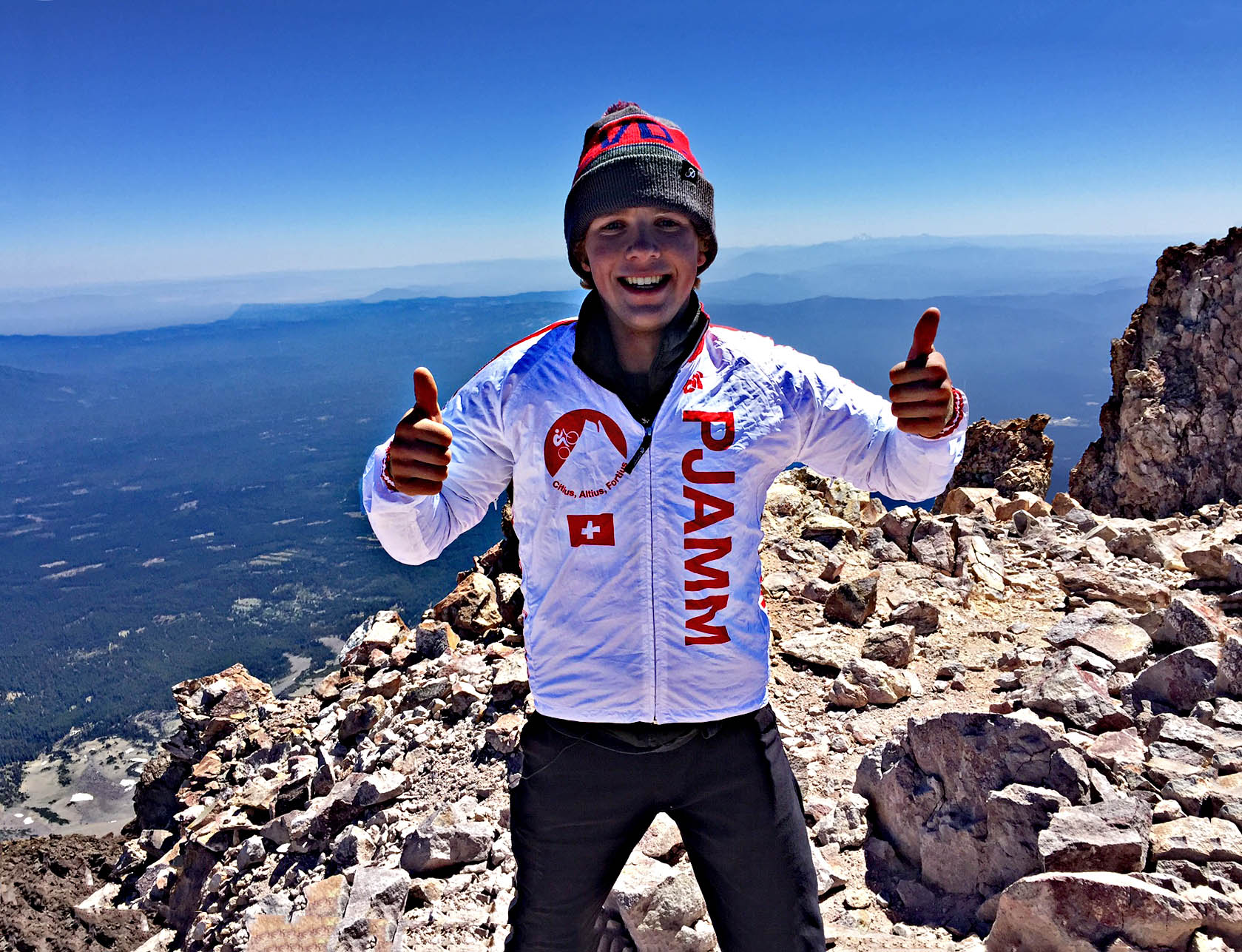 PJAMM Cyclist gives thumbs up at the summit of the Mt. Shasta bike climb.
