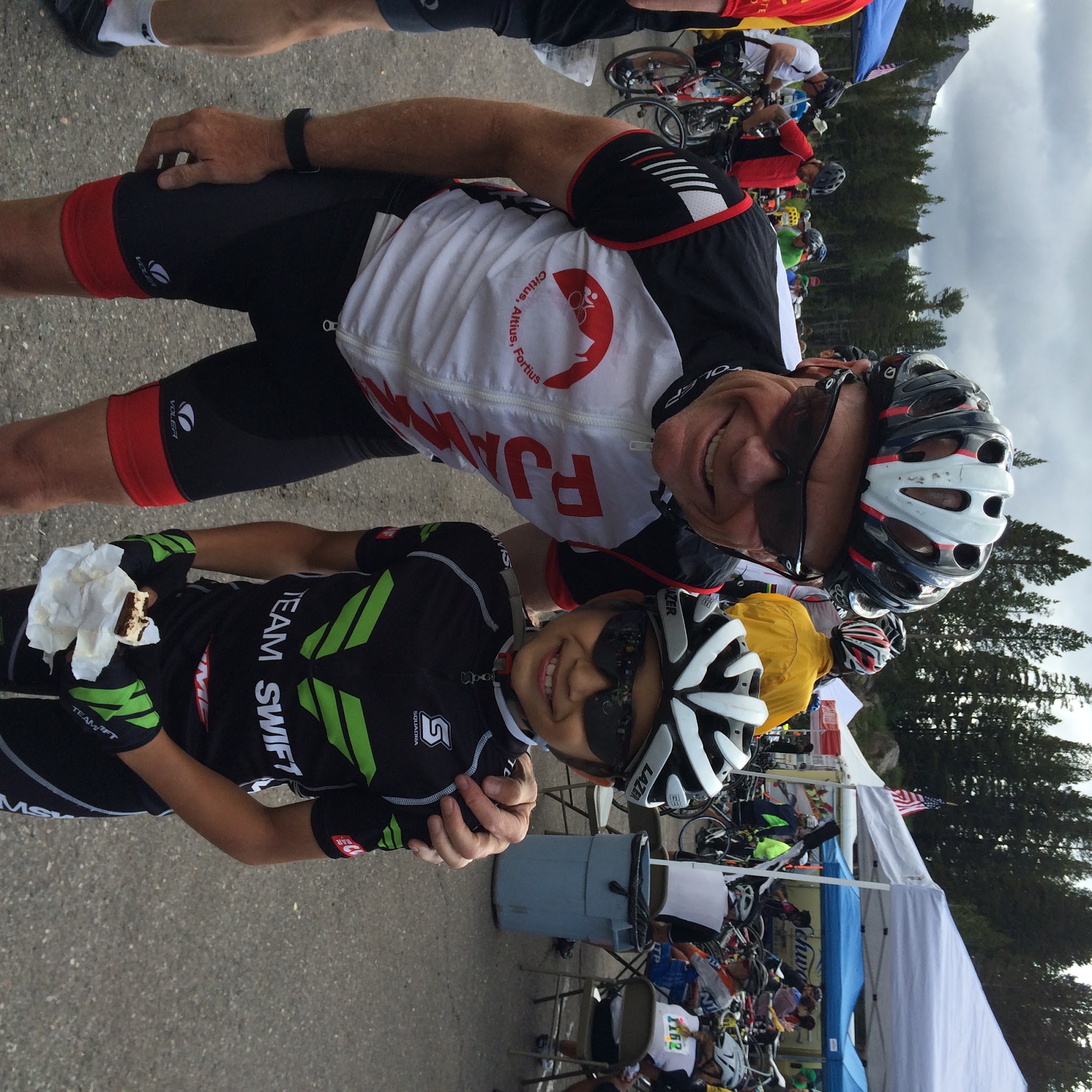 PJAMM Cyclist John Johnson stands with Team Swift member eating ice cream at the finish of the Death Ride