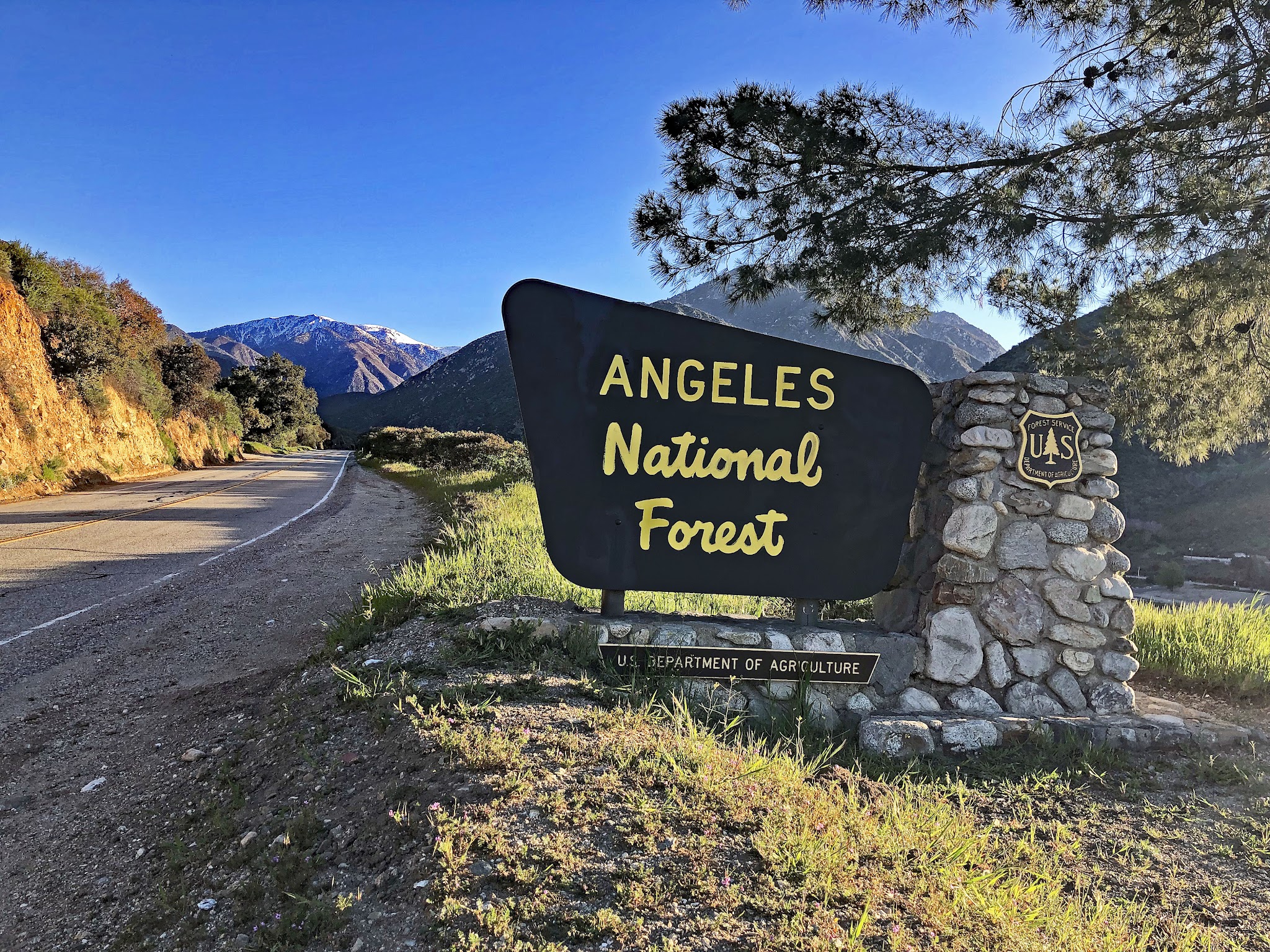 Cycling Mt. Baldy - cyclist on bike riding up to Mt Baldy Resort sign