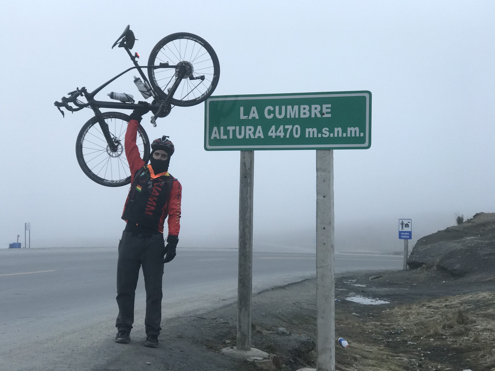 Bike ride and cycling Top World Bike Climbs  - pjamm cyclist holding up bike at La Cumbre summit sign