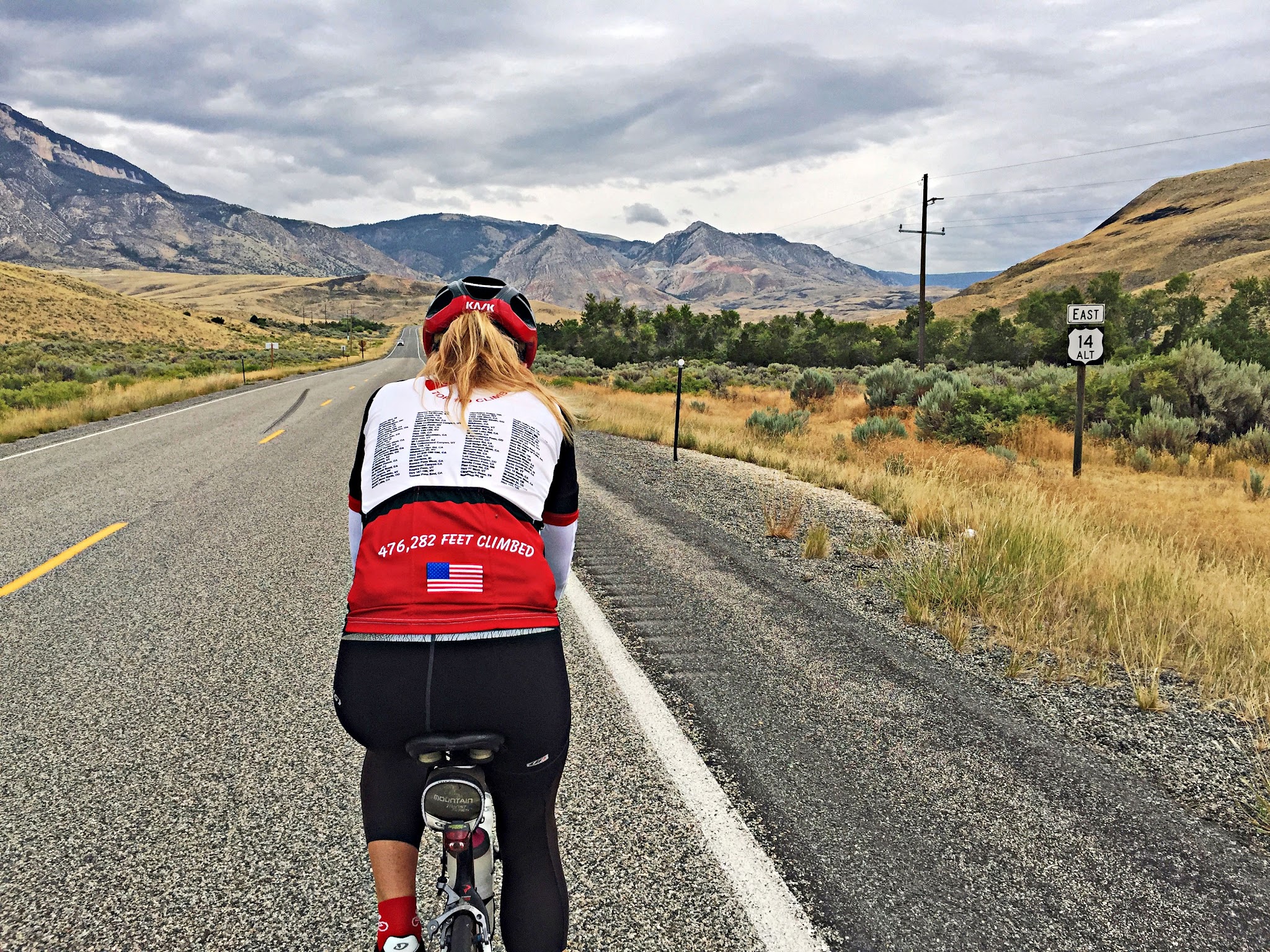 Cycling Alternate Route 14, Wyoming - cyclist riding on straight stretch of roadway