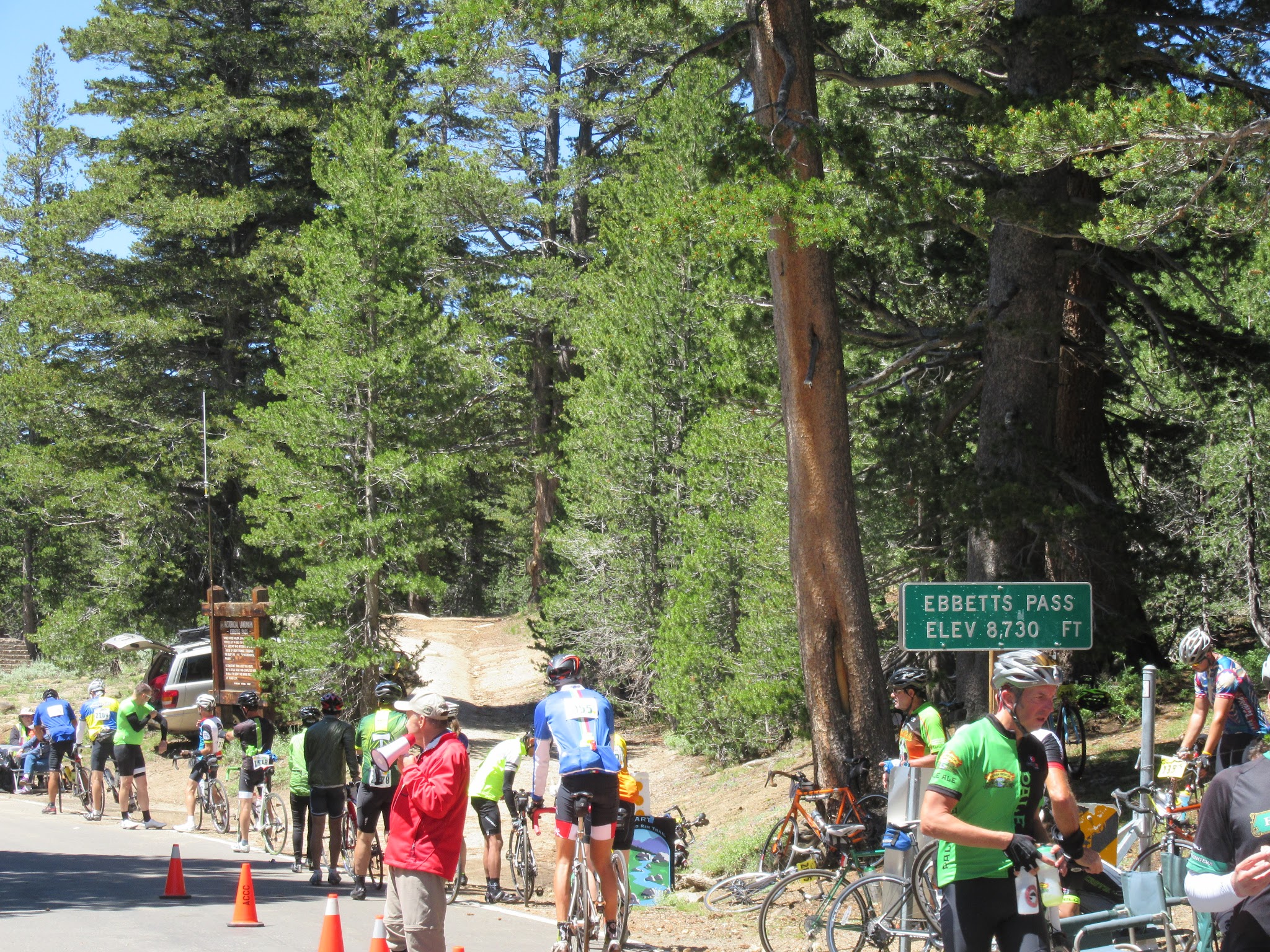 cycling Ebbetts Pass - Death Ride cyclists at pass with pass sign