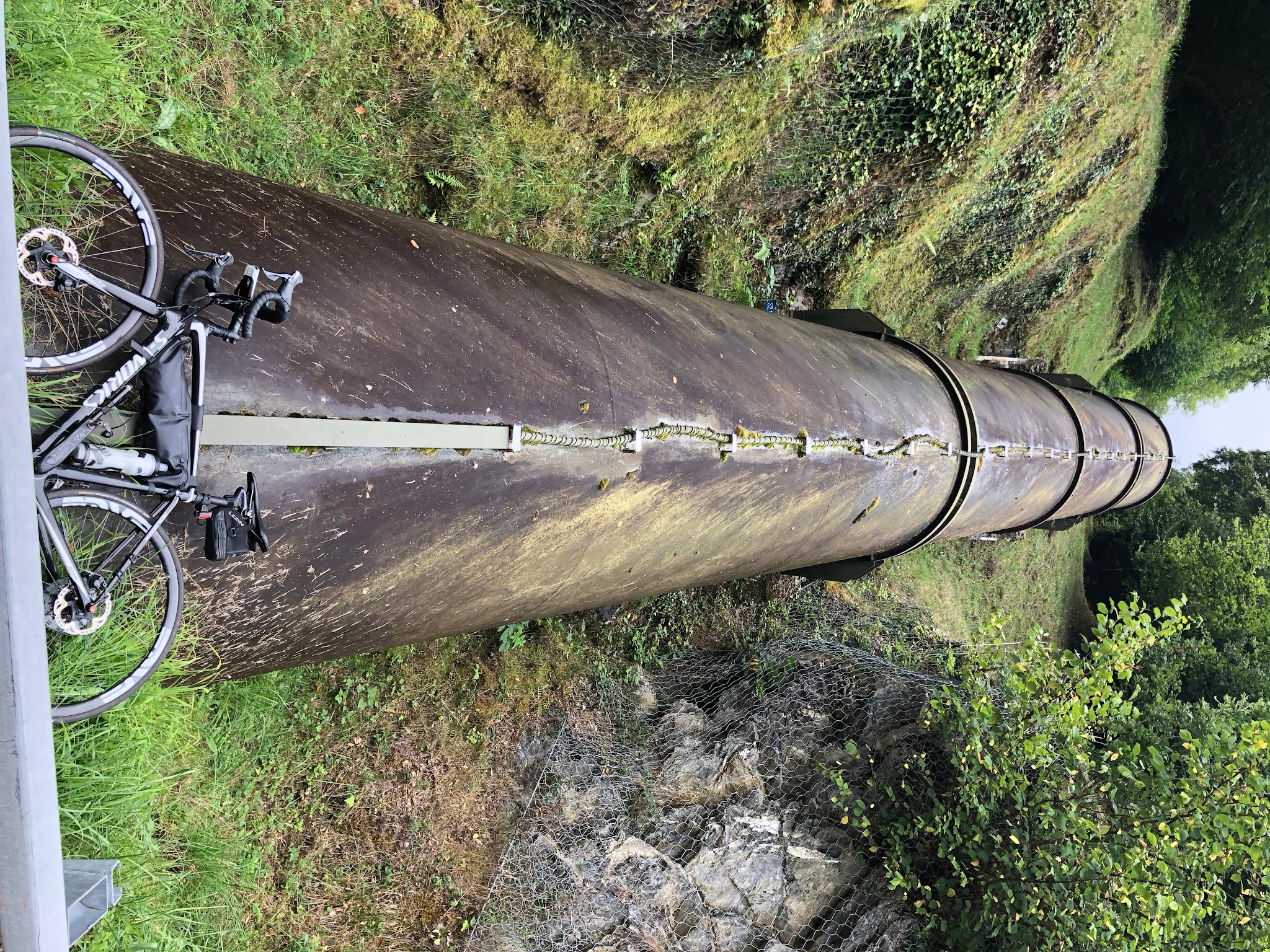 Bike climb of Luz Ardiden - hydroelectric water pipe with bike leaning against it.